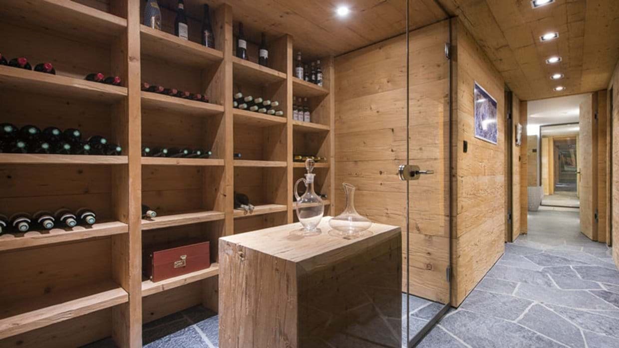 Temperature-controlled wine cellar with timber shelving and slate flooring