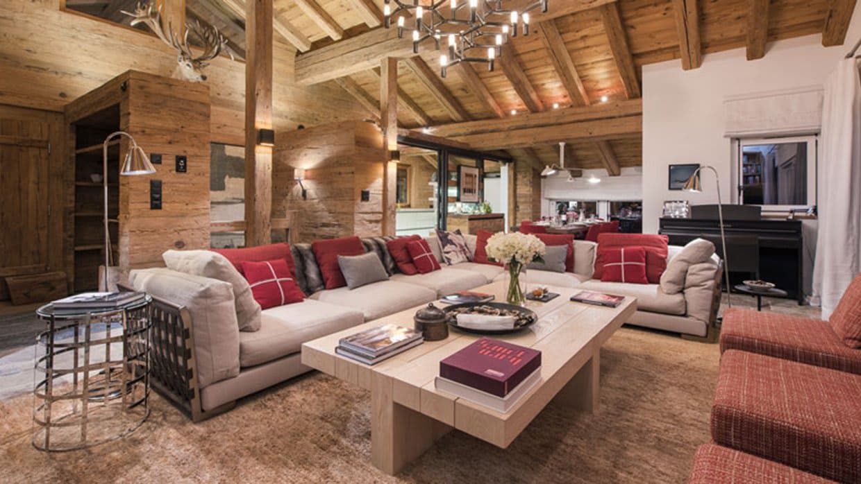 Open-plan living area featuring upright piano and vaulted timber ceilings