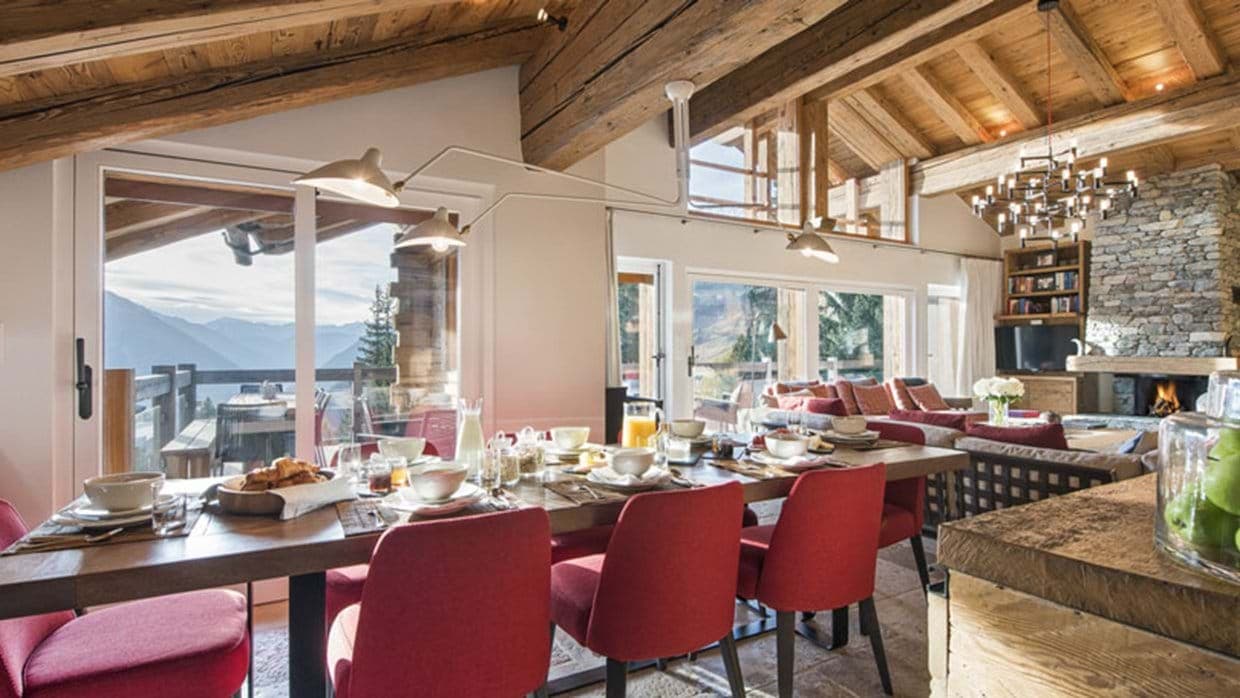 Open-plan dining area seating 10 with mountain views and balcony access