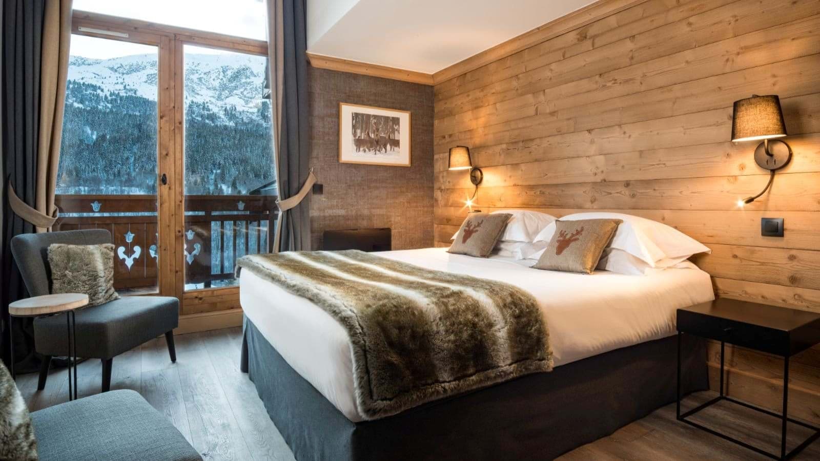 Bedroom with king bed and balcony access; mountain views