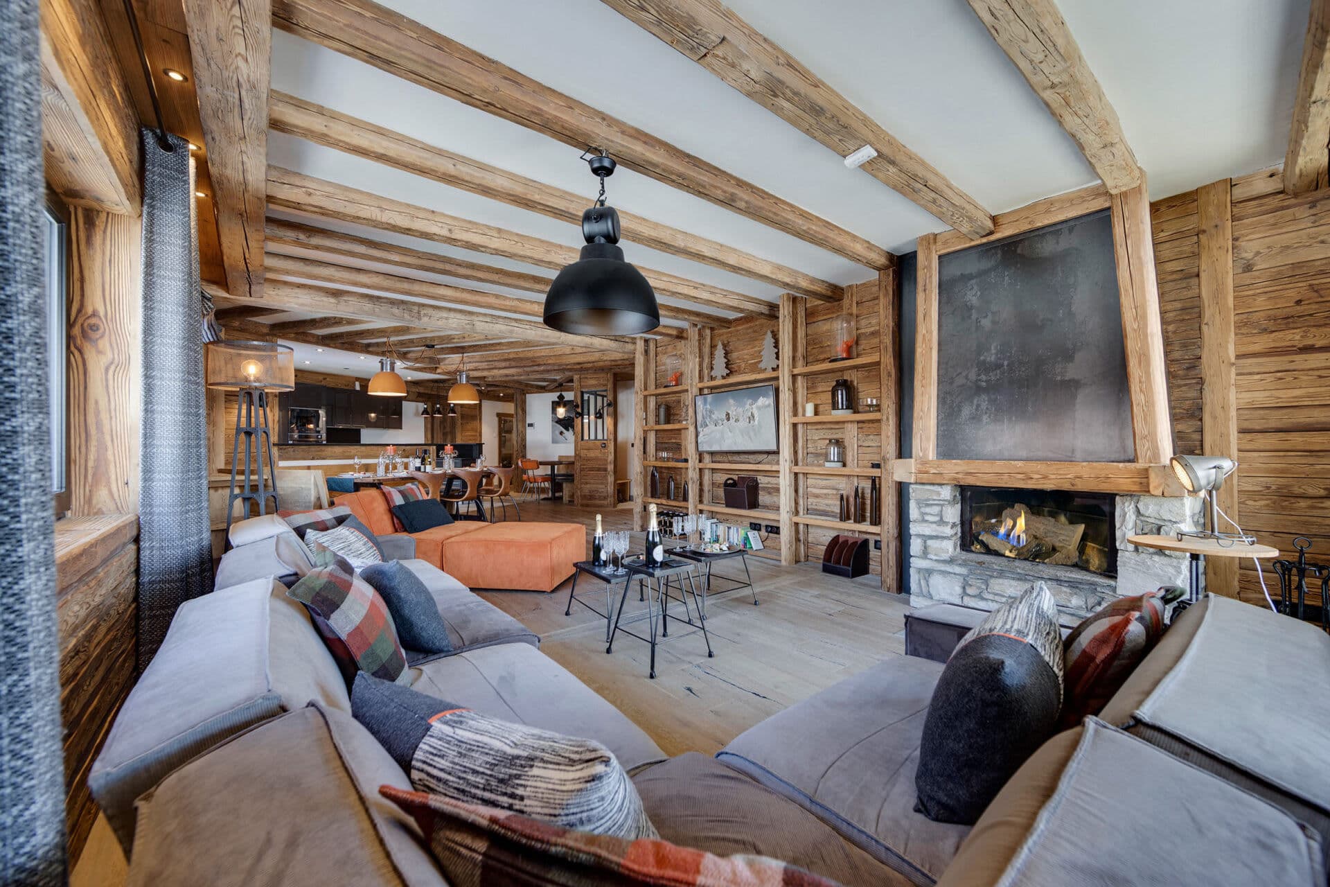 Living area with stone fireplace and exposed timber beams