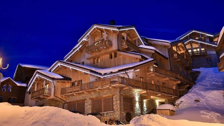 Ski-in/ski-out timber chalet with private balconies and stone-clad base