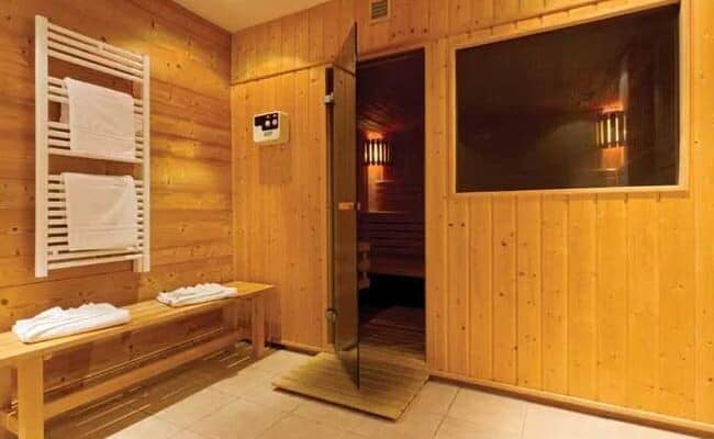 Private sauna with heated towel rack and changing bench