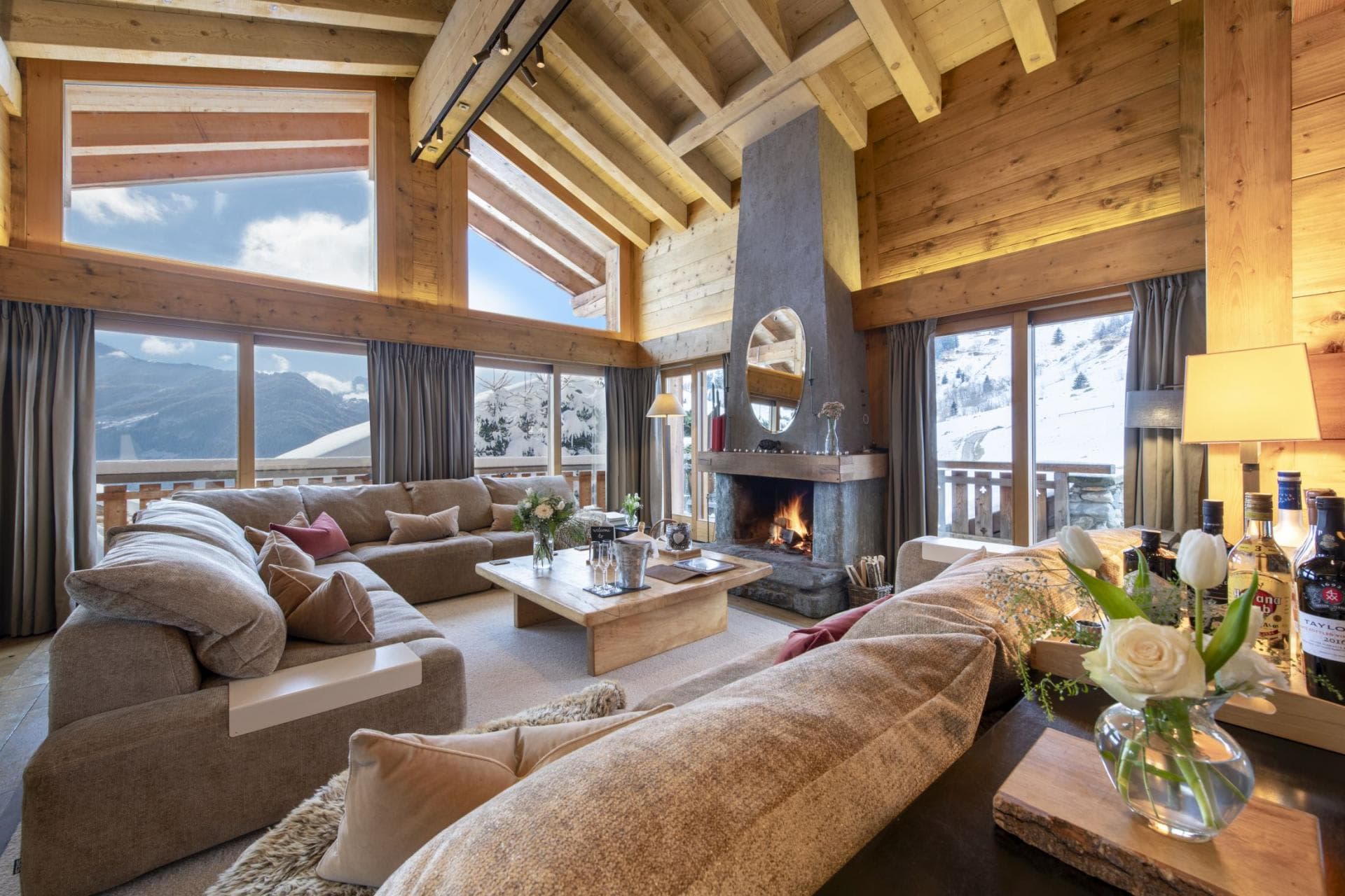 Living room with wood-burning fireplace and mountain views