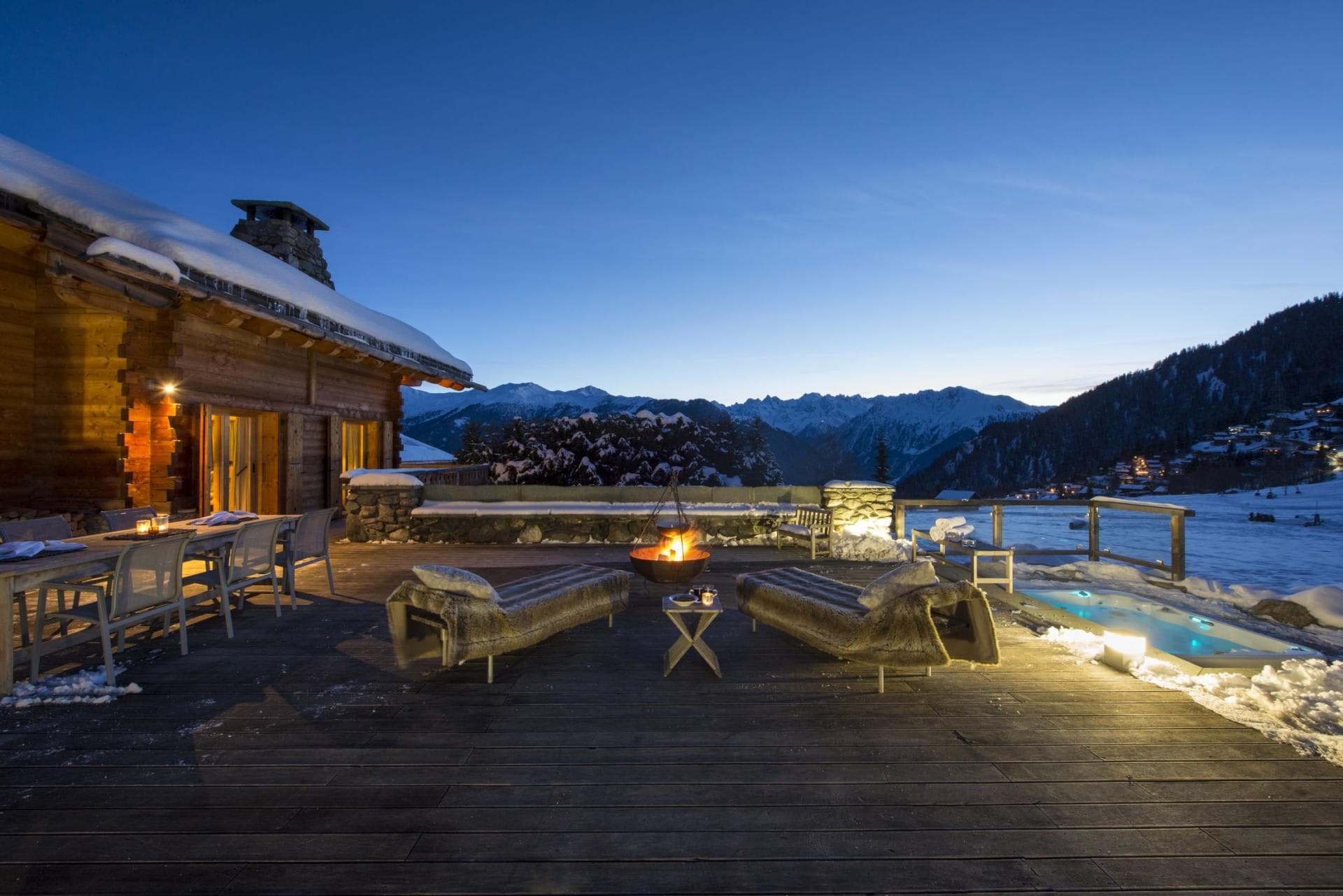 Terrace with fire pit, sunken hot tub, and panoramic mountain views