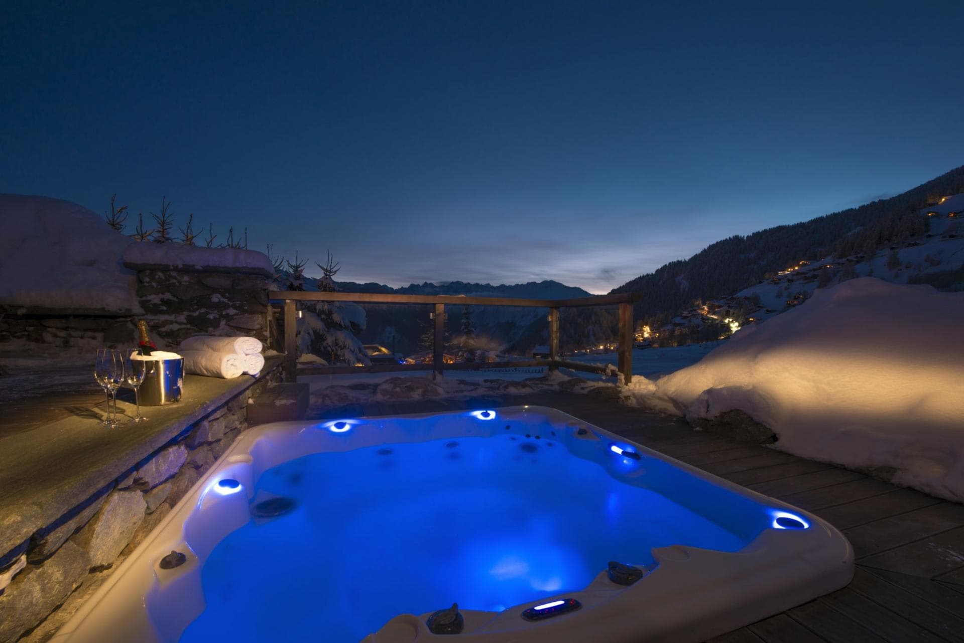Outdoor hot tub overlooking mountain valley and village lights