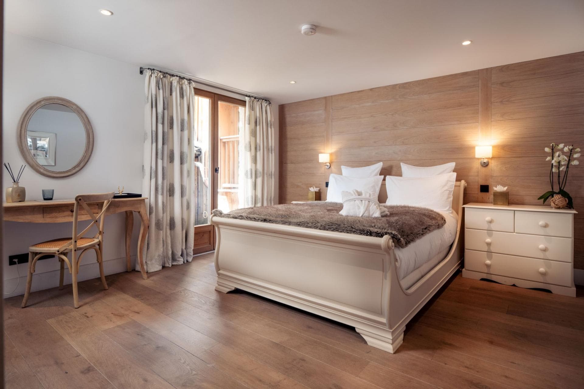 Bedroom with sleigh bed, writing desk, and balcony access