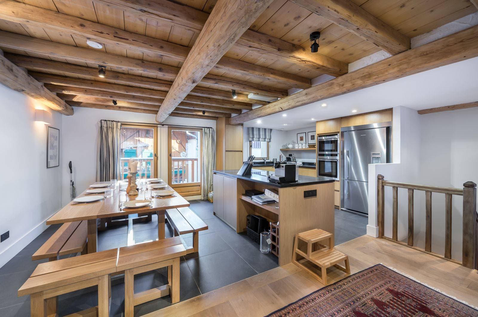 Open-plan kitchen and dining area with original timber beams; seats 8