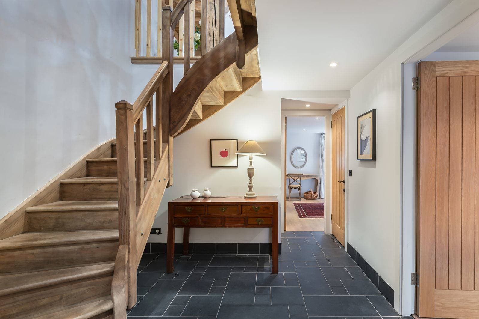 Entrance hallway with slate tile flooring and oak staircase