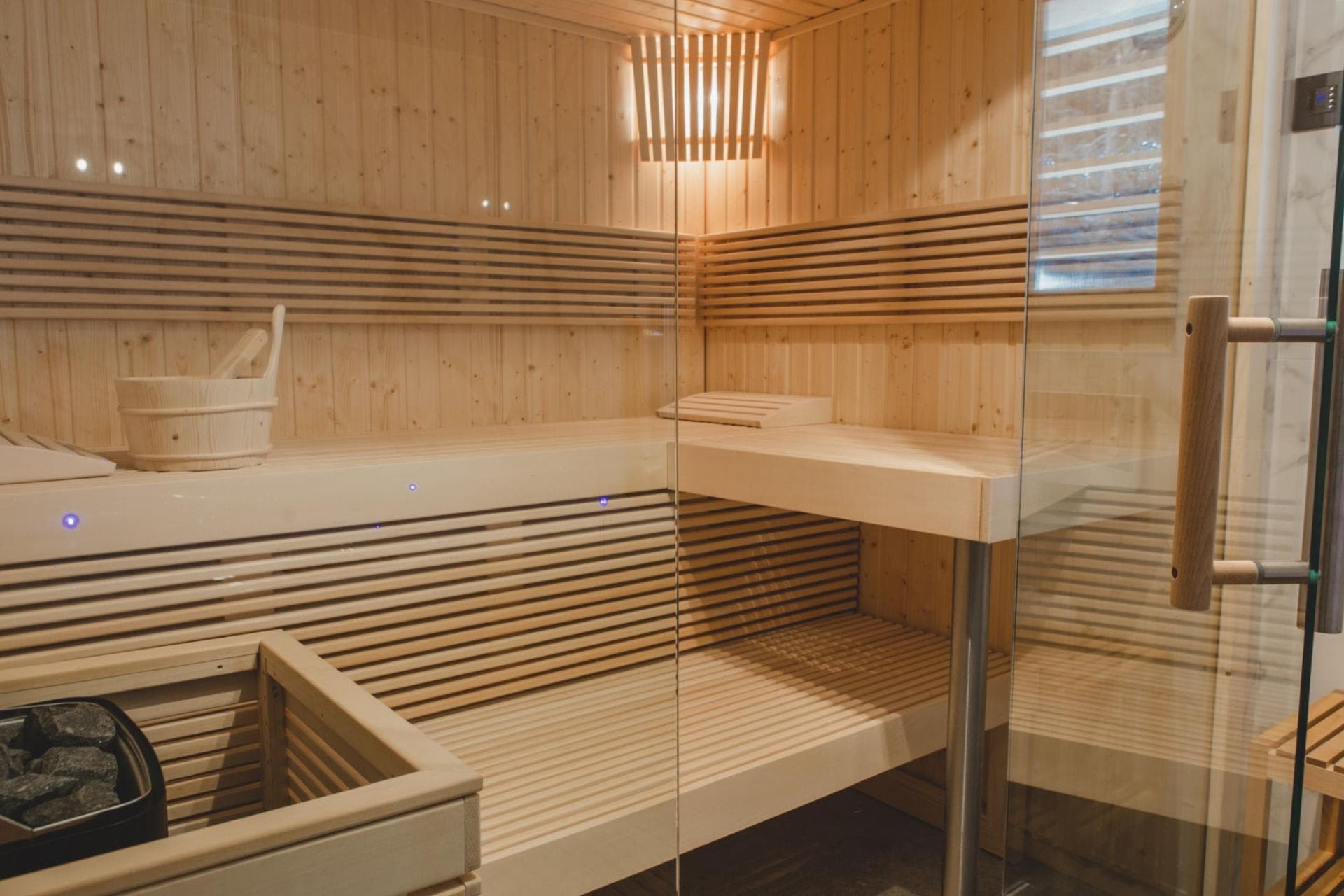 Private cedar sauna with tiered seating and electric heater