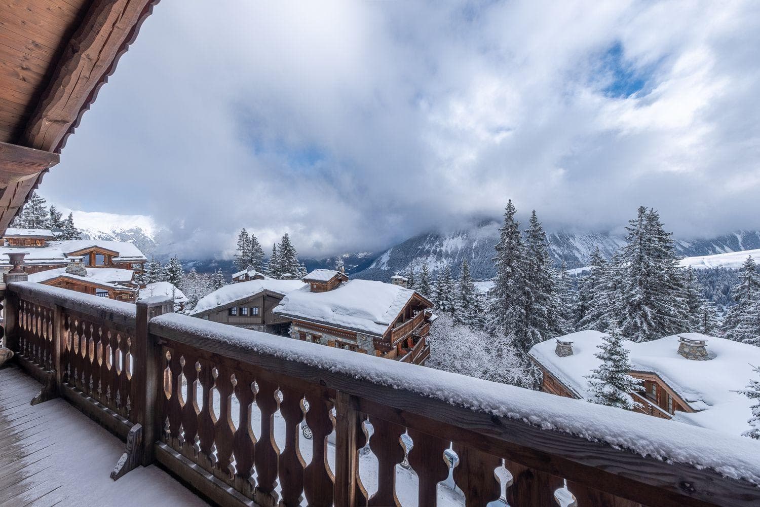 Private balcony with views of snow-covered chalets and alpine mountains