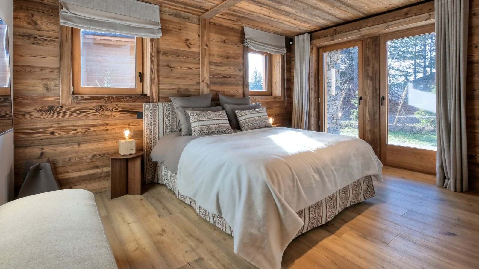 Wood-paneled bedroom with king bed and direct garden access