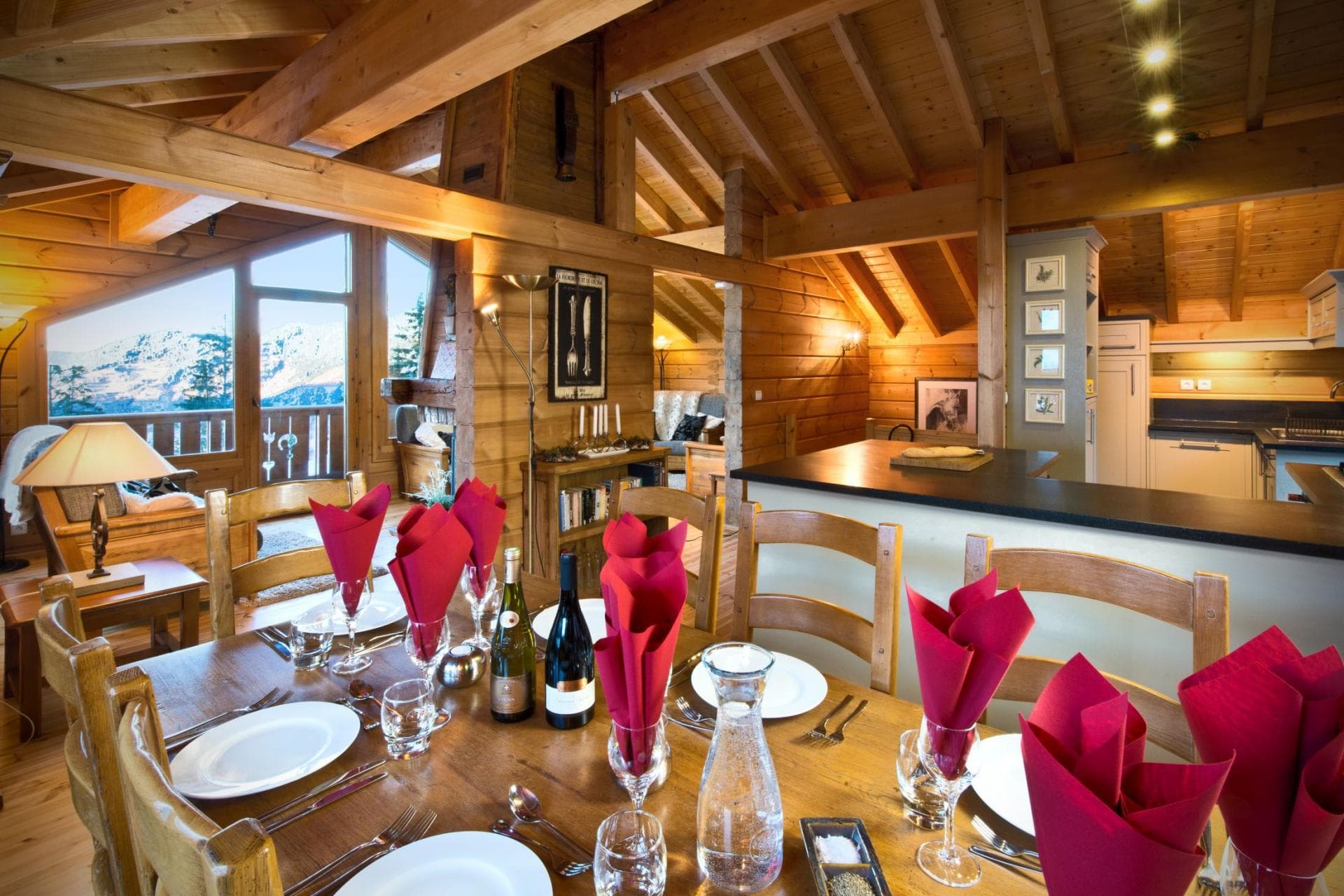 Open-plan dining area seating 8 with mountain views and adjacent kitchen