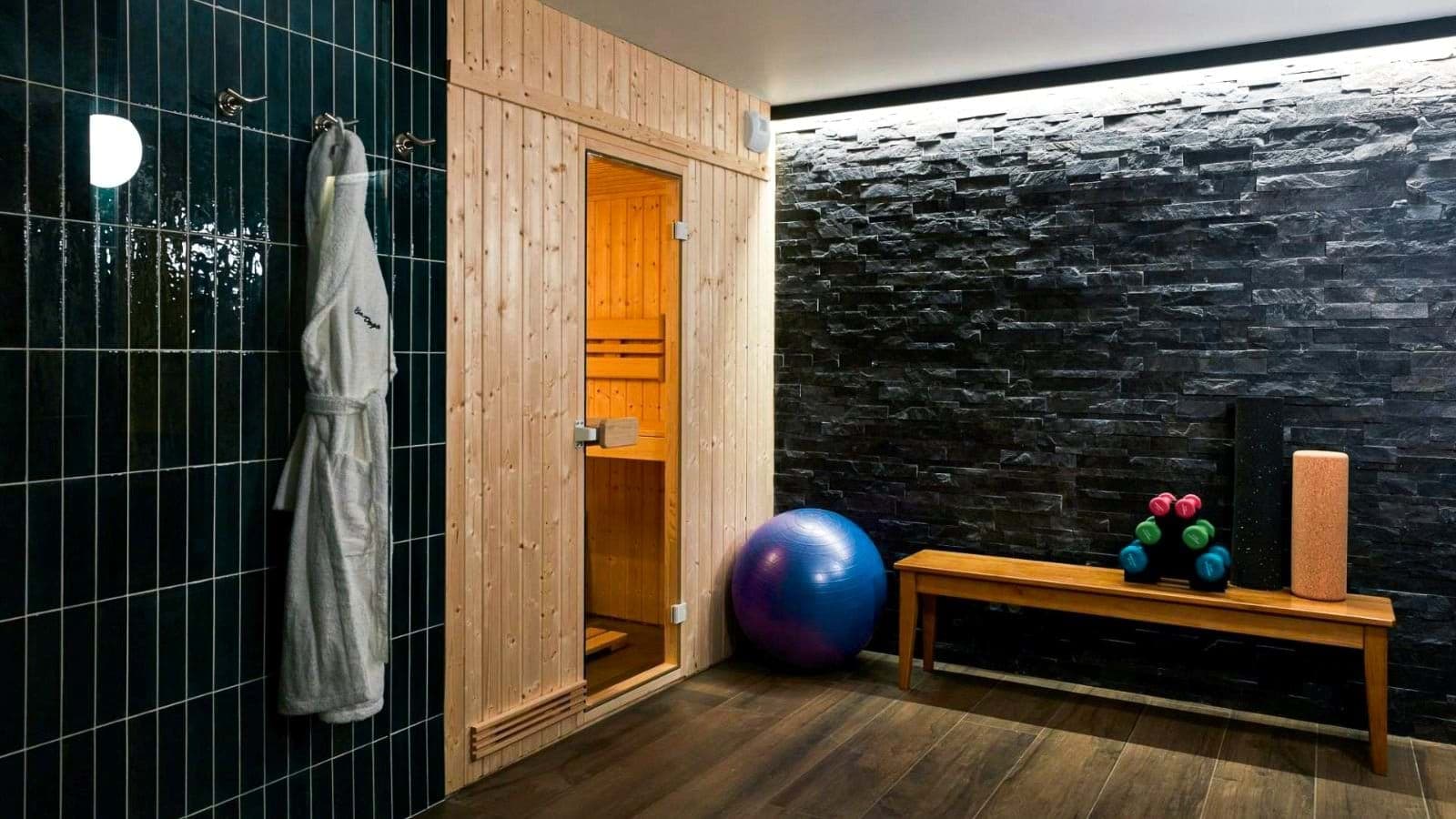 Private wooden sauna and gym with weights and yoga ball