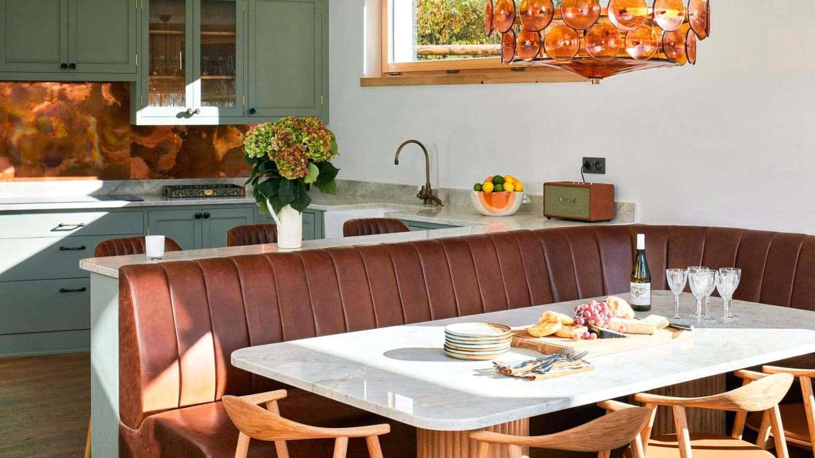Kitchen with copper backsplash and leather banquet seating for six