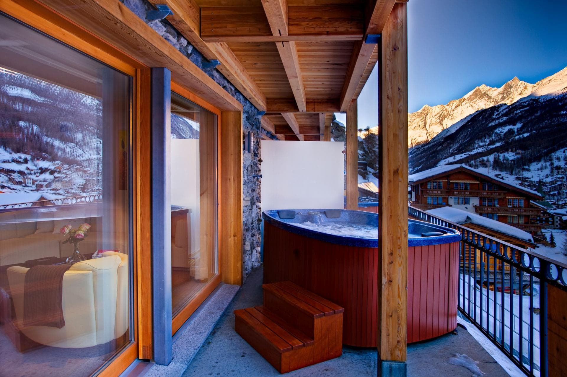 Covered balcony hot tub with Alpine mountain views