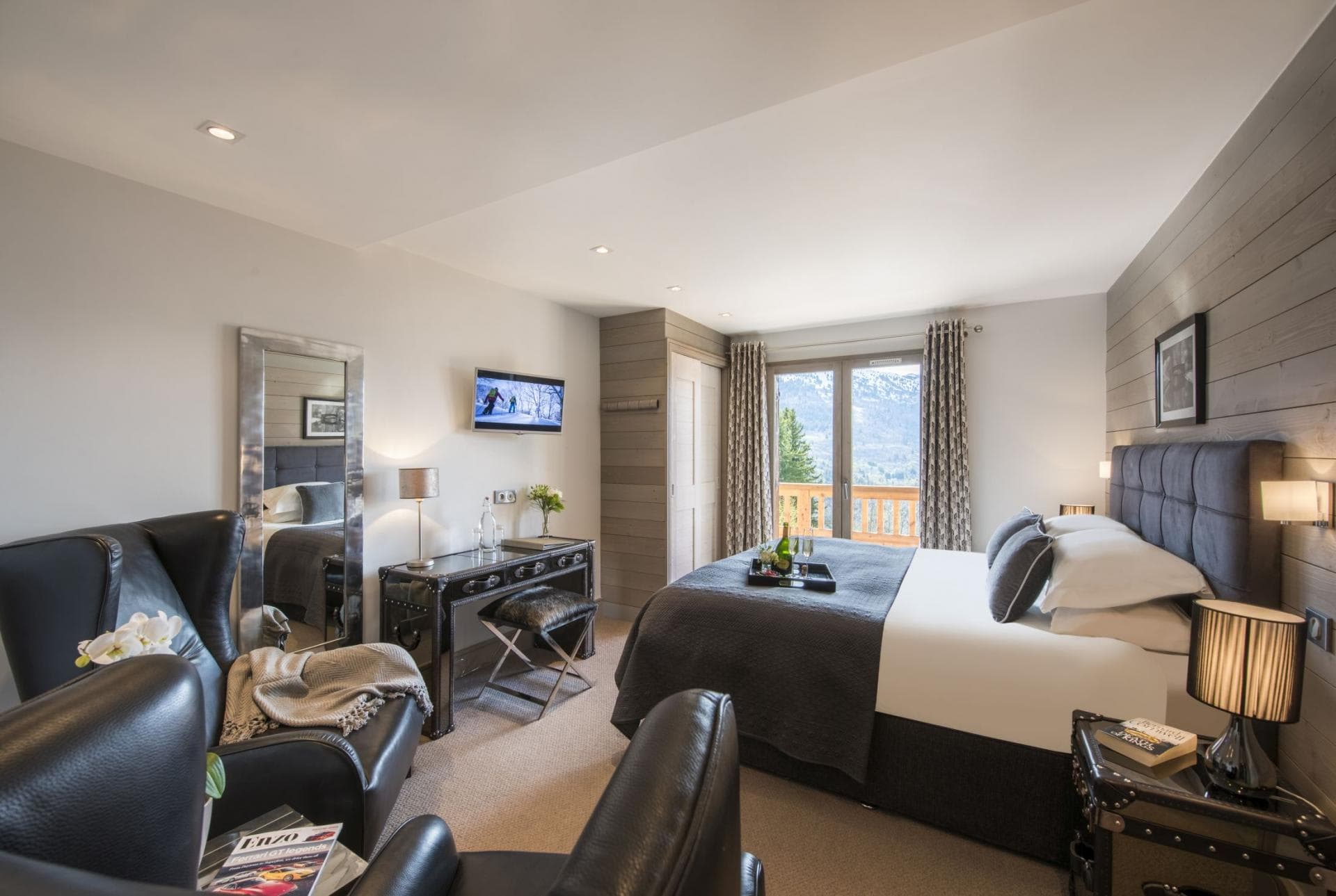 Primary bedroom with king bed and balcony access to mountain views