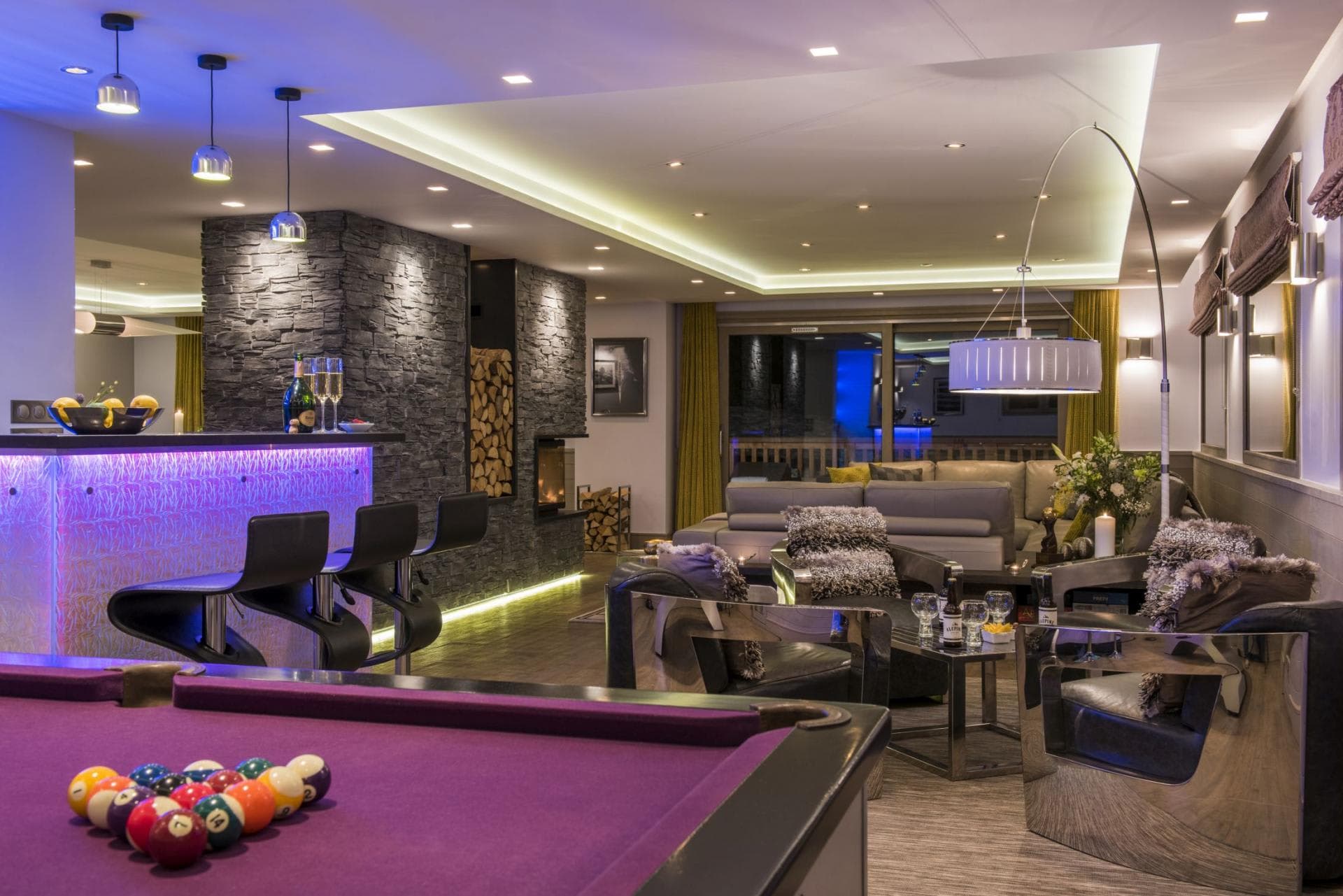 Entertainment lounge with pool table, wet bar, and wood-burning fireplace