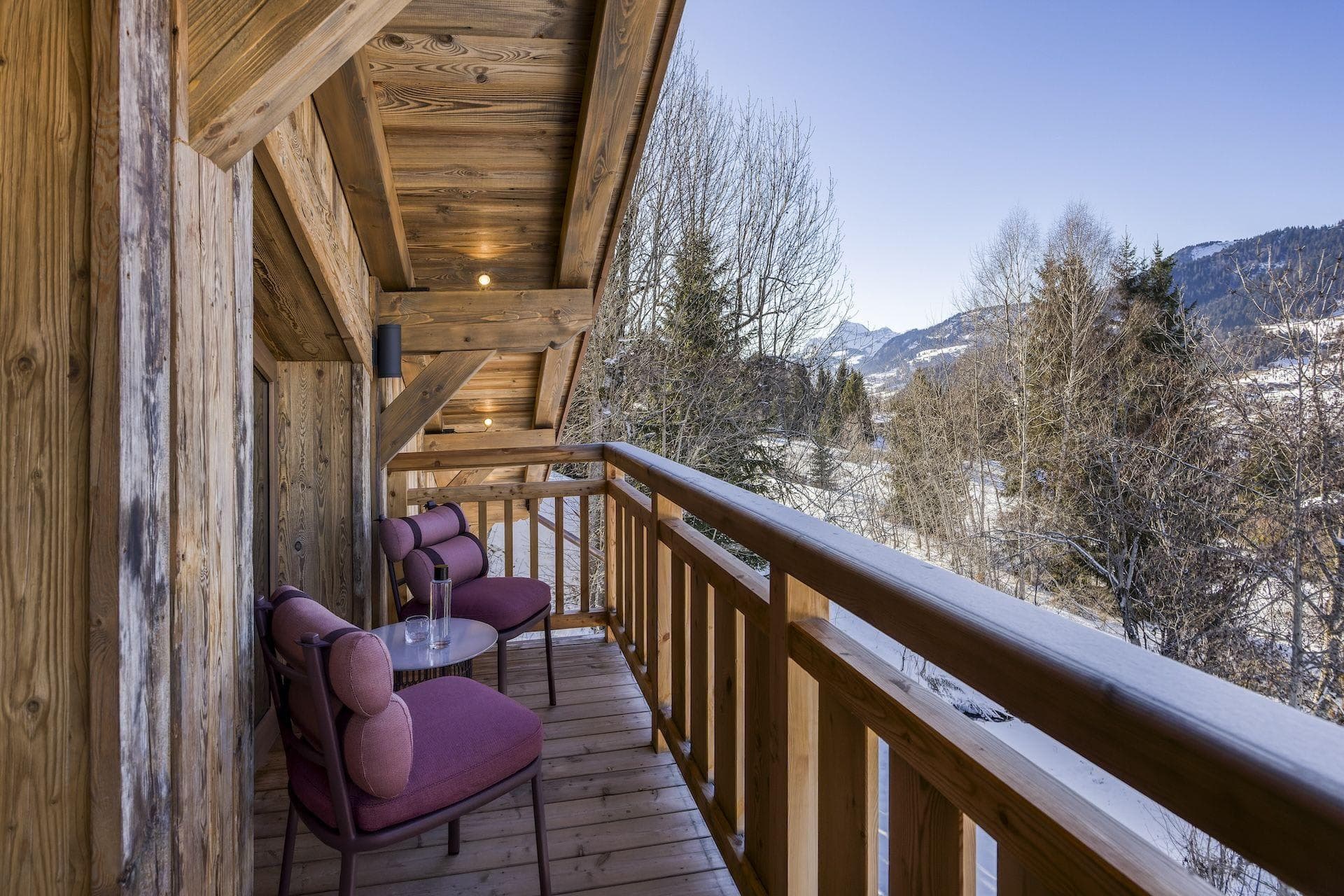 Covered balcony with seating for two and mountain views