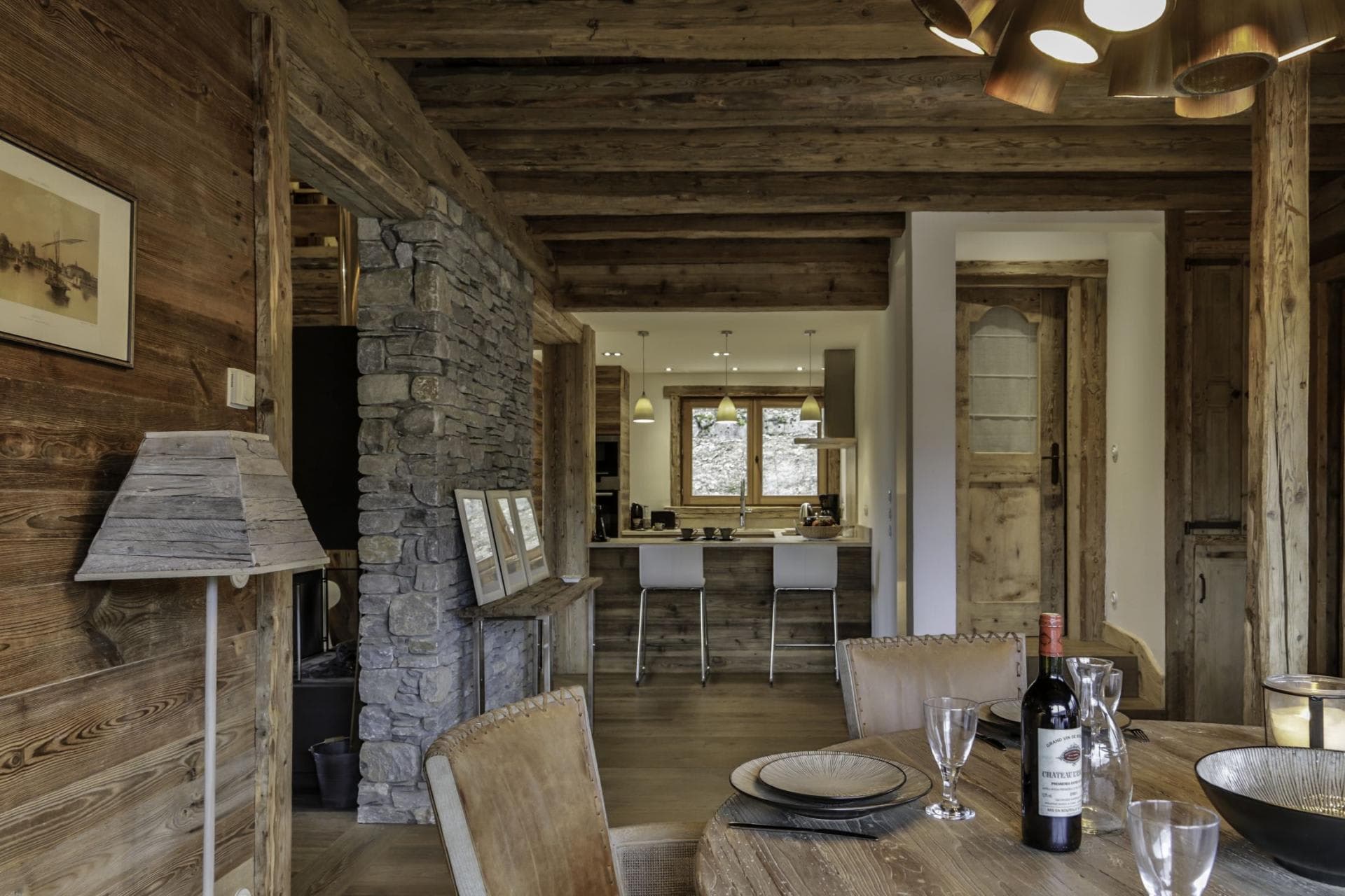 Open-plan dining area leading to kitchen with breakfast bar seating