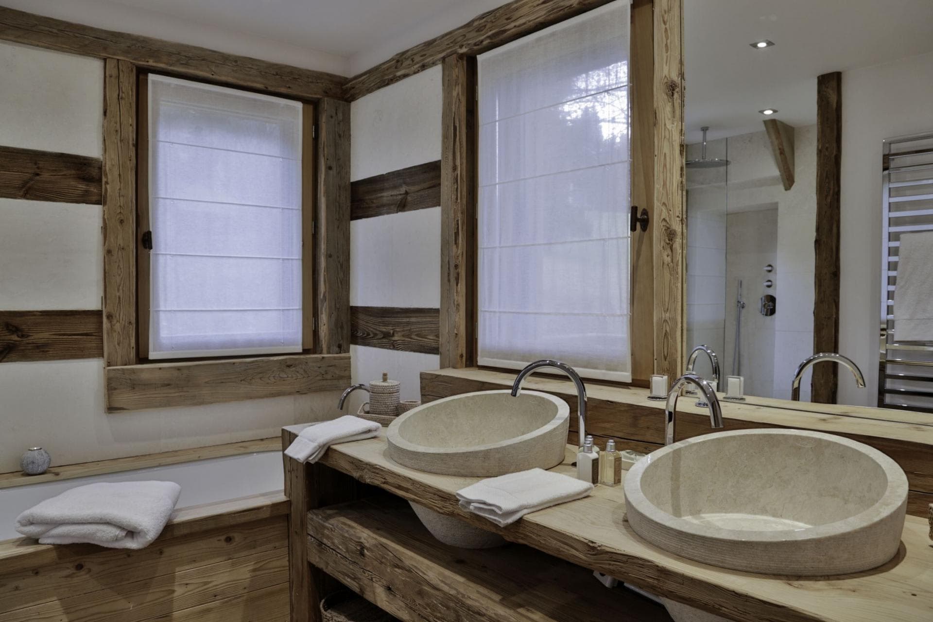 Bathroom with dual stone vessel sinks and walk-in rainfall shower
