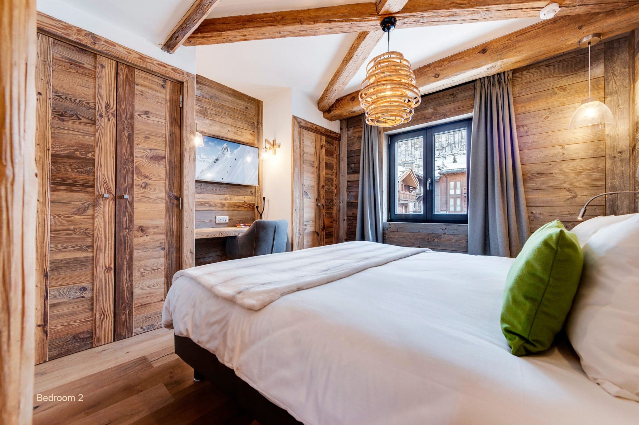 Guest bedroom featuring a dedicated workspace and built-in wardrobes