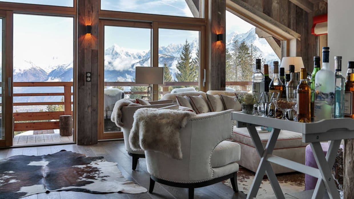 Living area with well-stocked bar cart and panoramic Alpine views