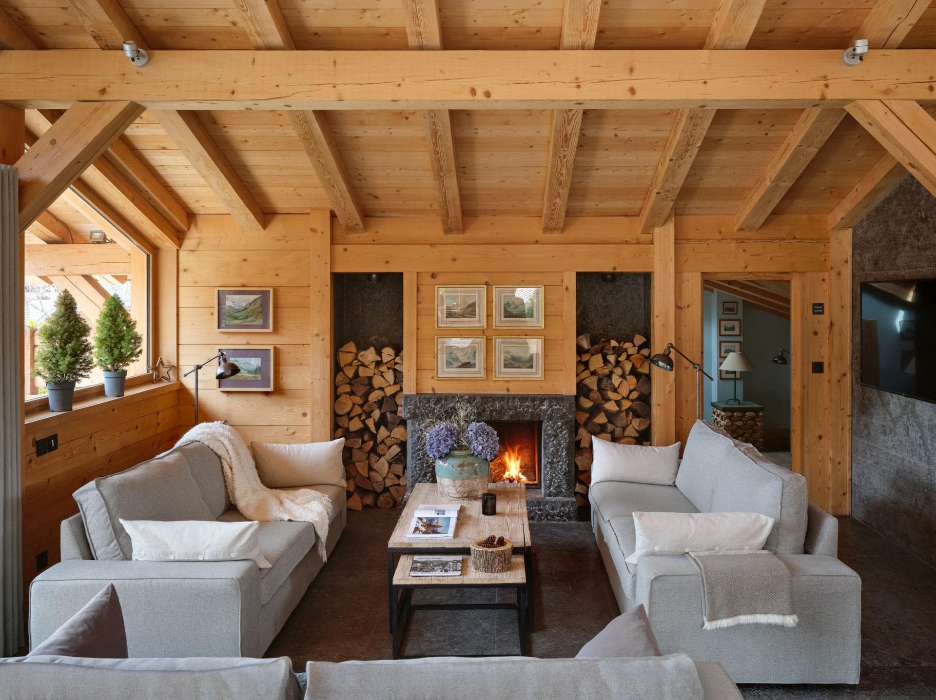 Living area with wood-burning fireplace and exposed timber beams