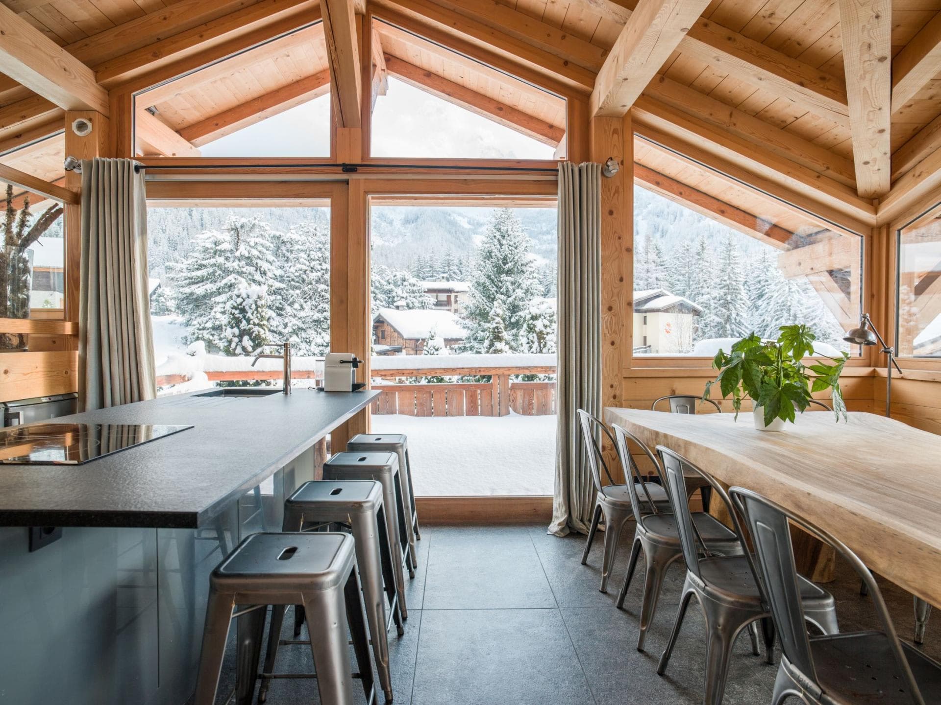 Open-plan dining and kitchen area with island seating for 4 and mountain views