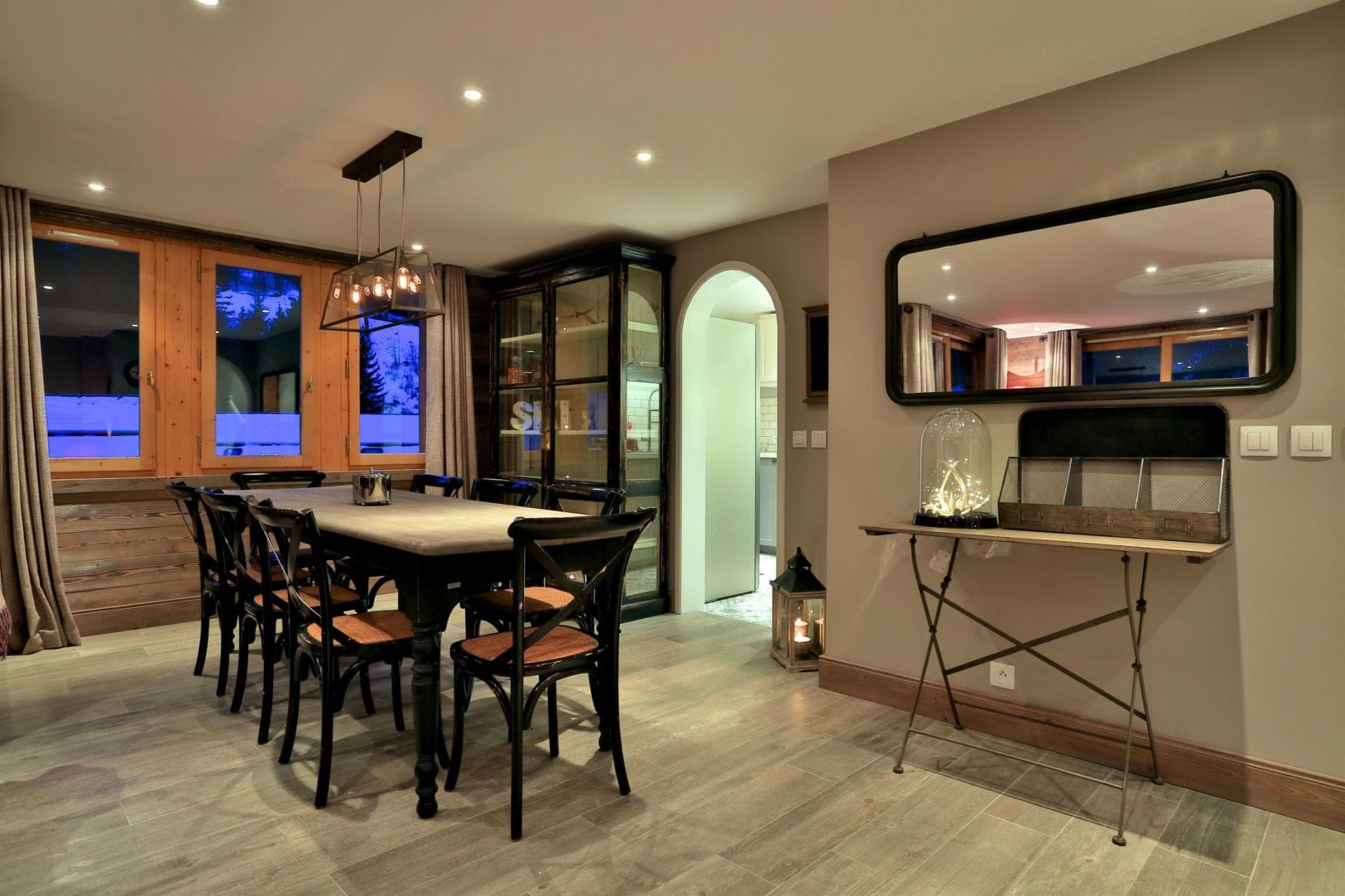 Dining area with seating for 8 and views of snow-covered pines