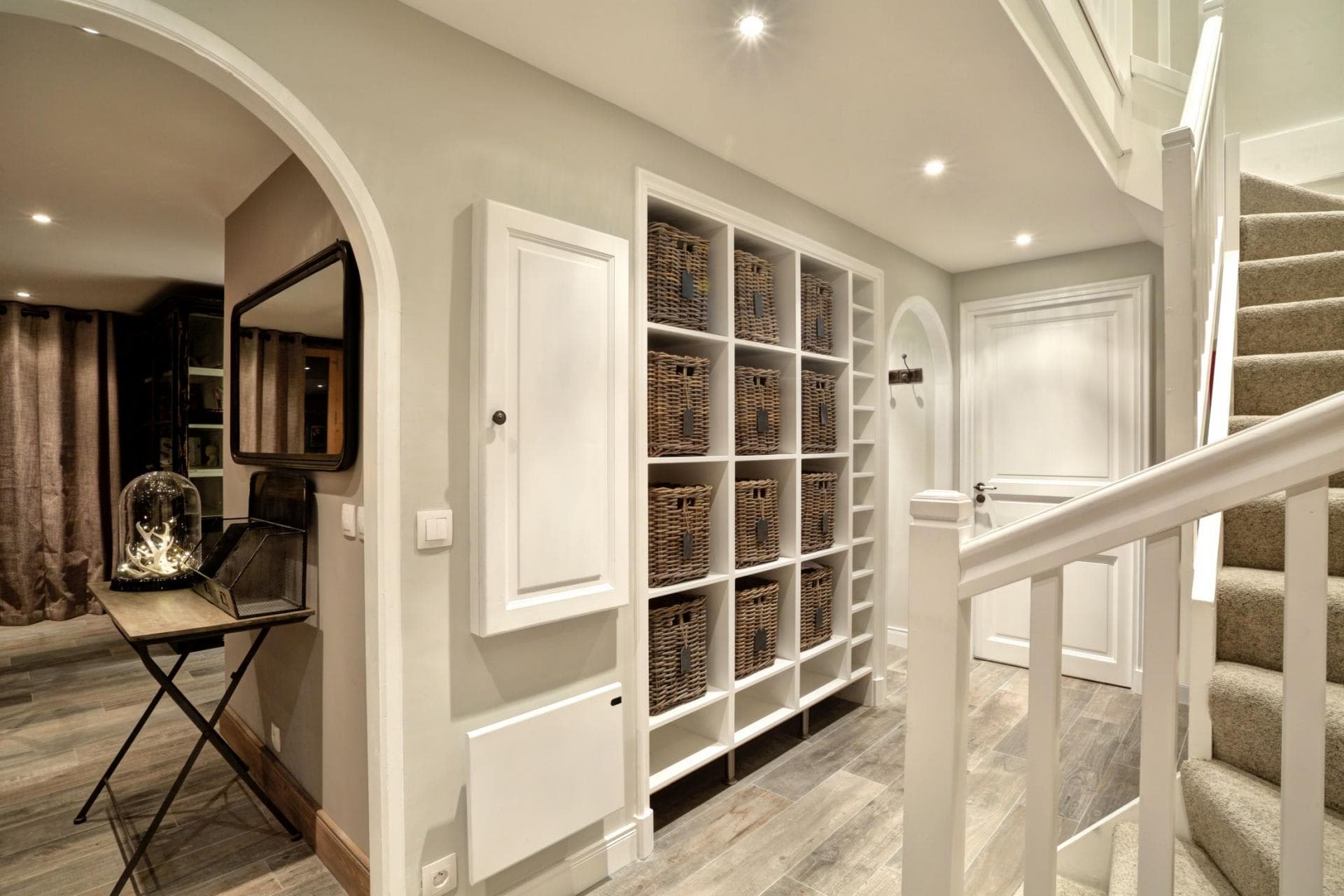 Lower level entryway featuring built-in cubbies with wicker storage baskets