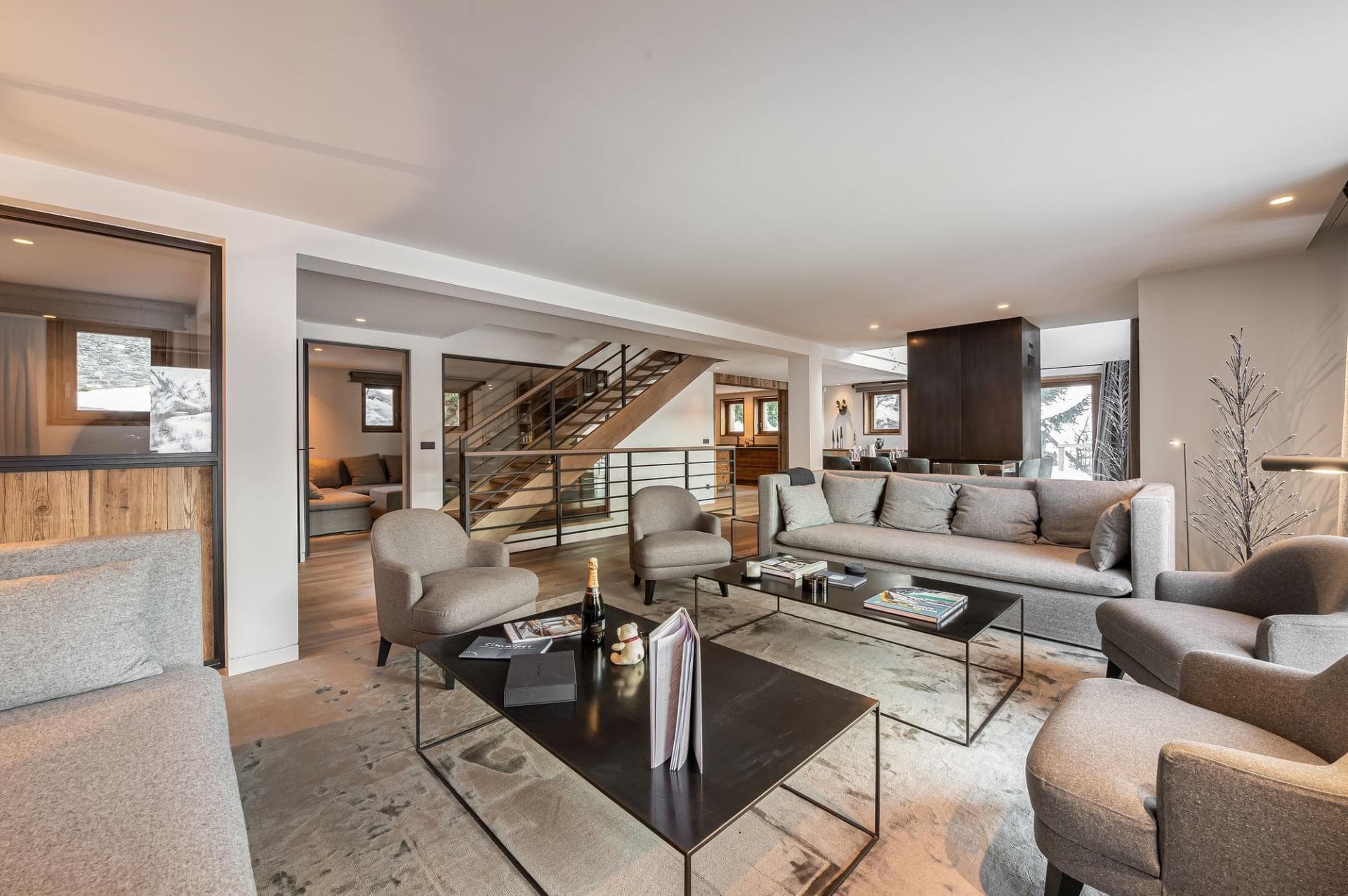 Open-plan living area with seating for 10 near stairs and media room