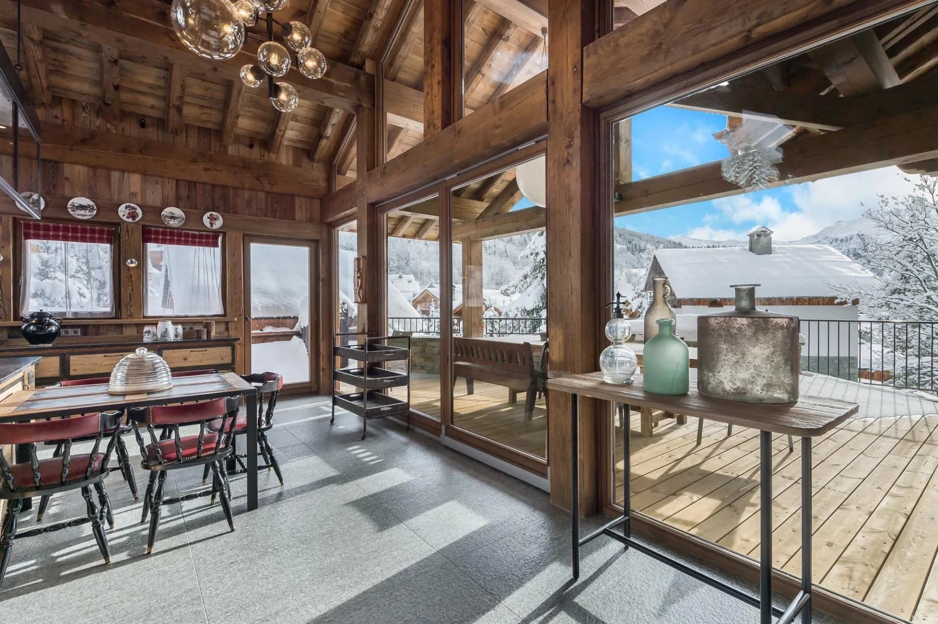 Dining area beneath a vaulted timber ceiling with mountain views