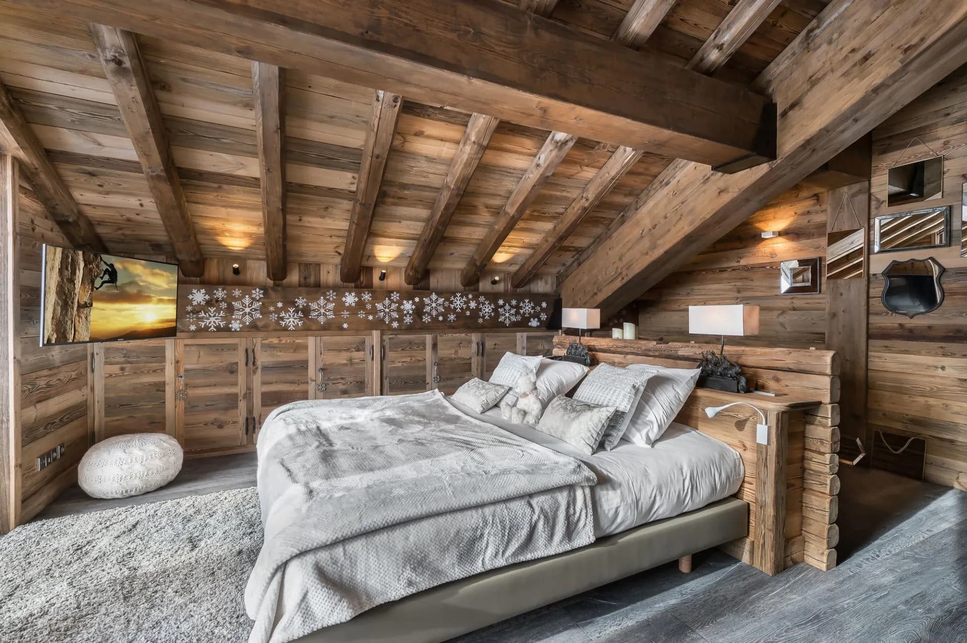 Double bedroom with built-in storage beneath a vaulted timber ceiling