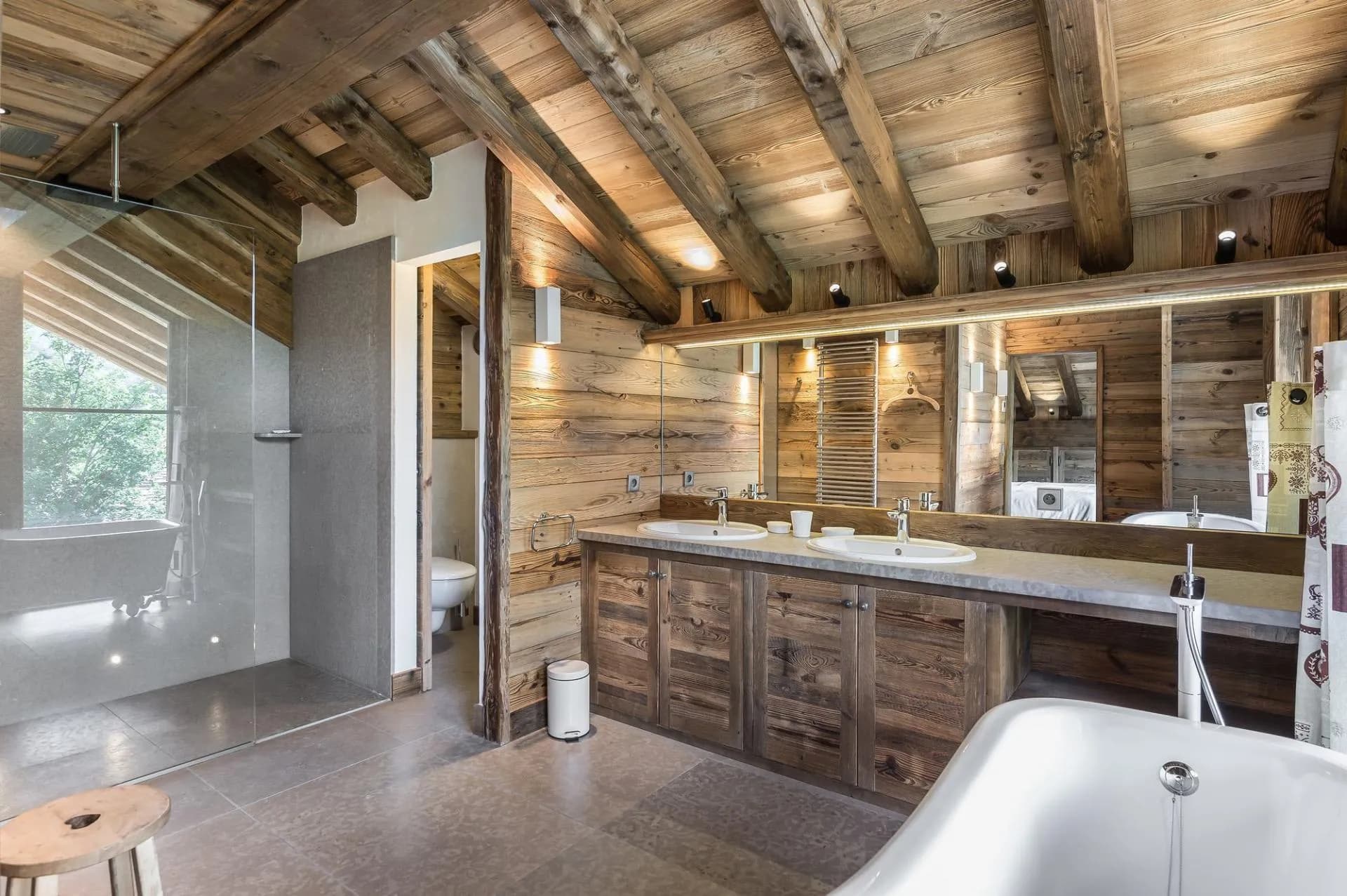 Bathroom with twin basins, a glass shower and freestanding bath