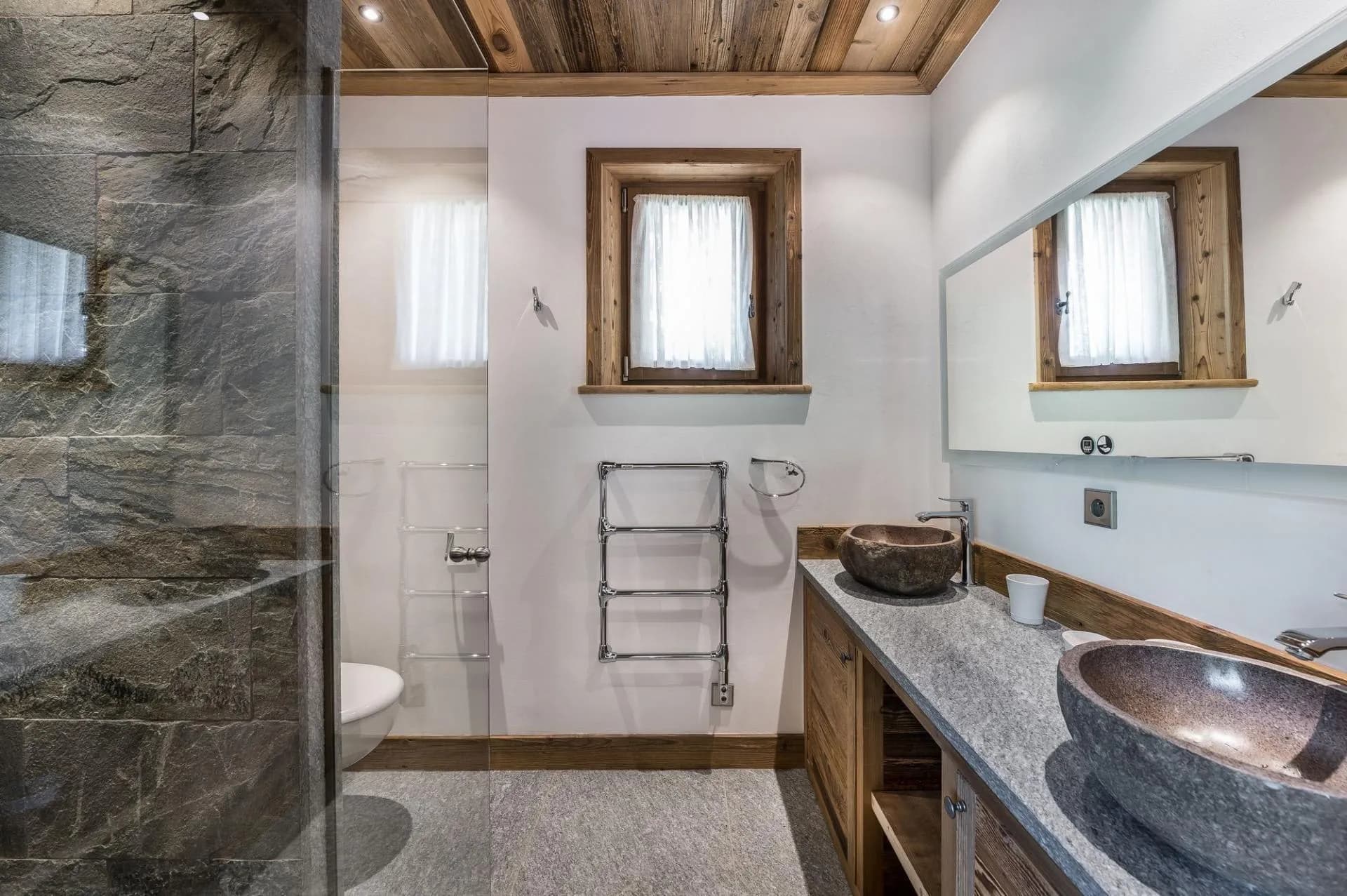 Bathroom with twin stone basins and a heated towel rail