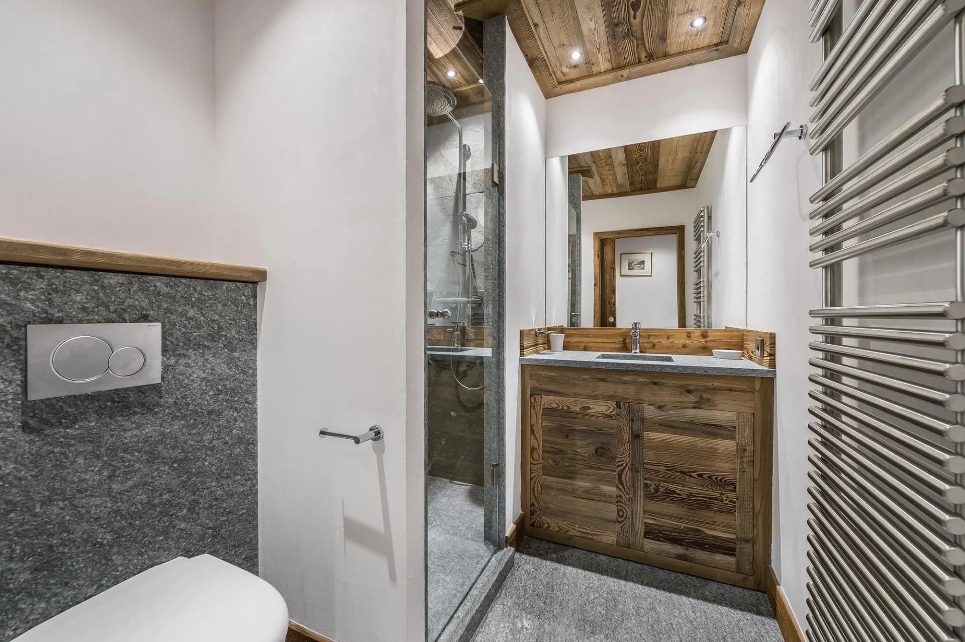 Shower room with a timber vanity and heated towel rail