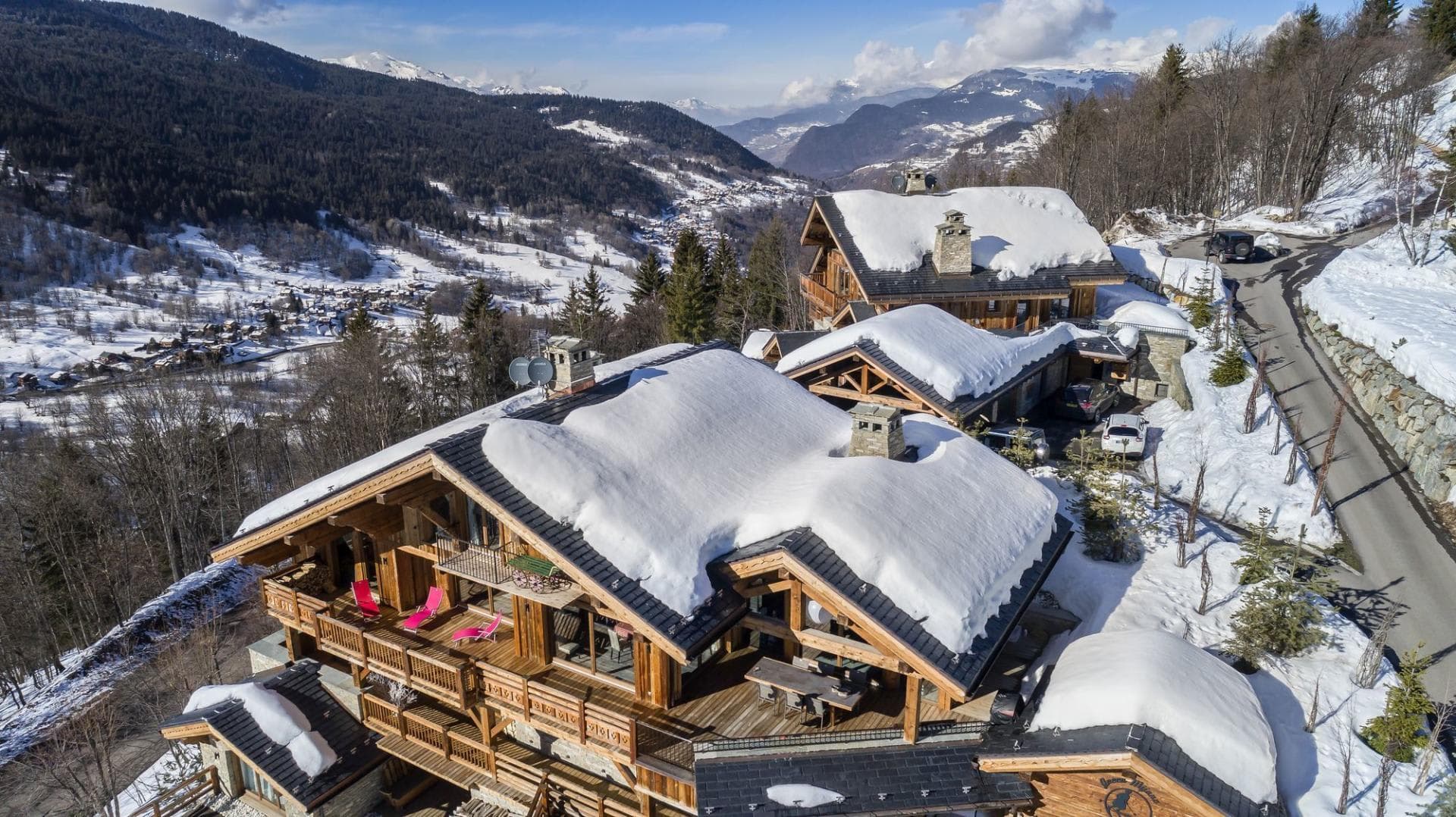 Chalet exterior with multiple tiered decks and panoramic valley views