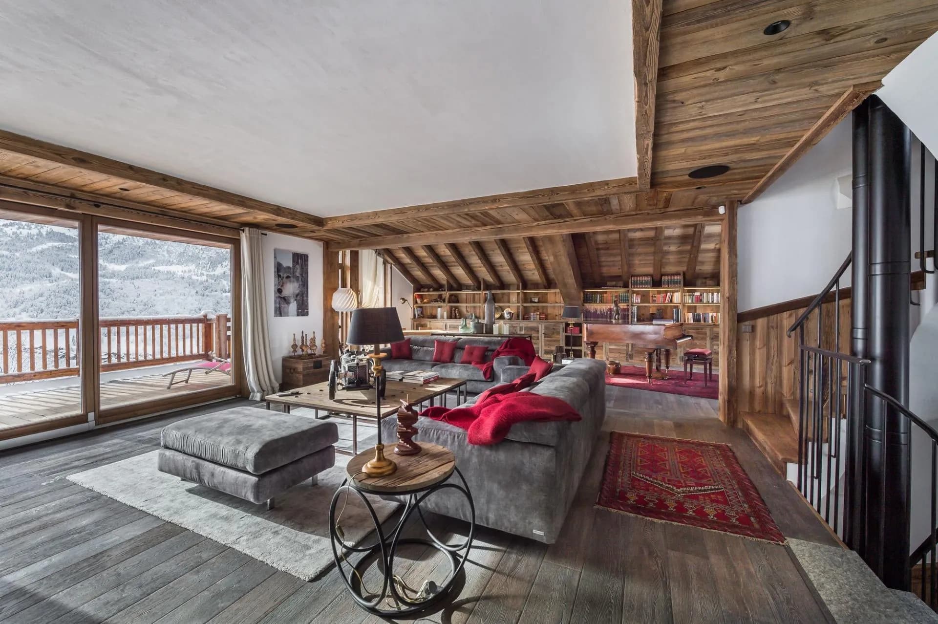 Living area with sectional seating, a grand piano and mountain views