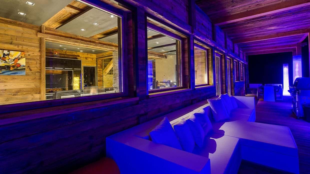 Covered outdoor lounge with gas grill and sectional seating