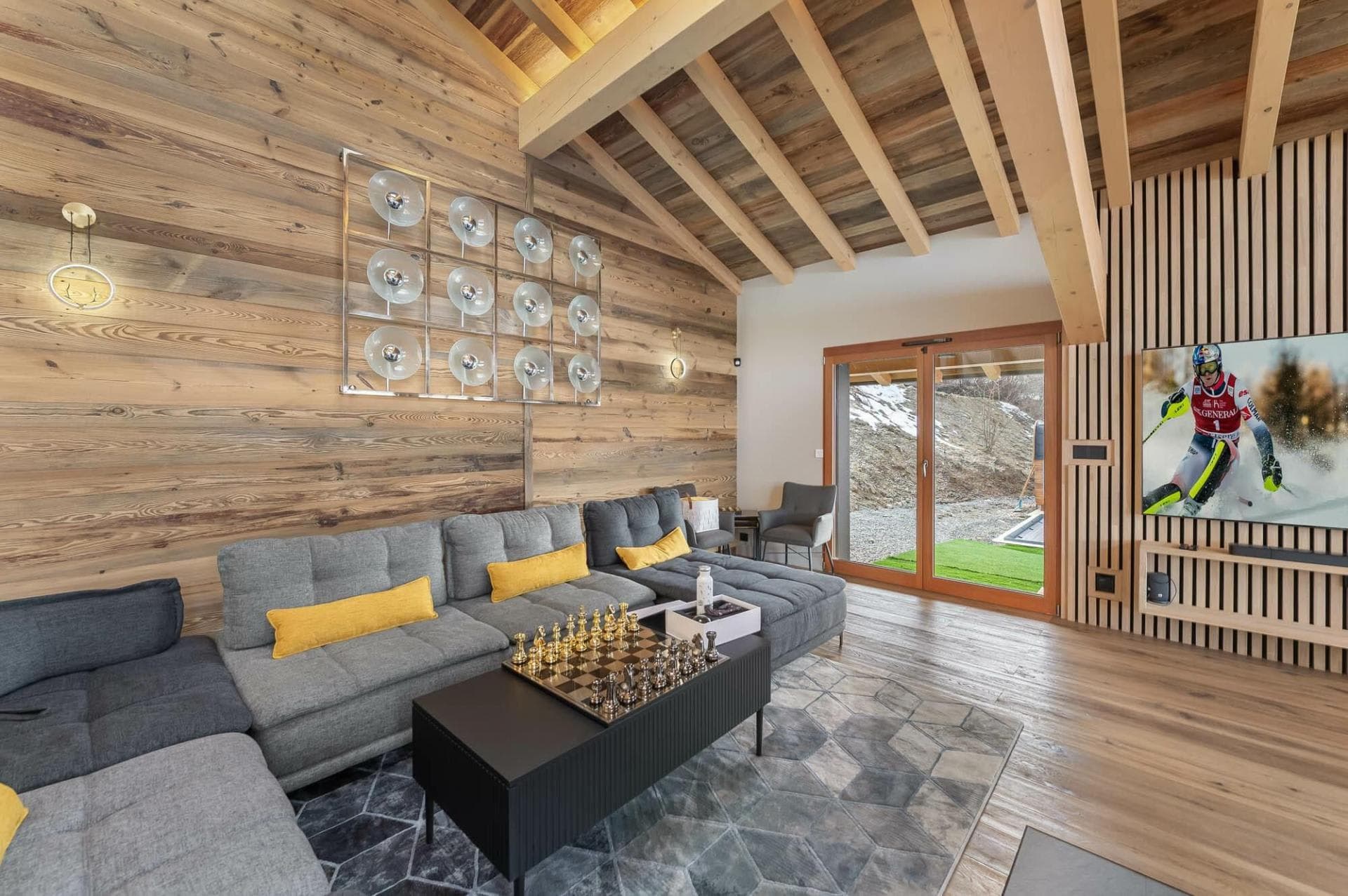 Media room with sectional seating and sliding door to garden