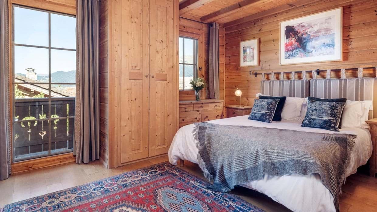 Bedroom with king bed and balcony access; mountain views
