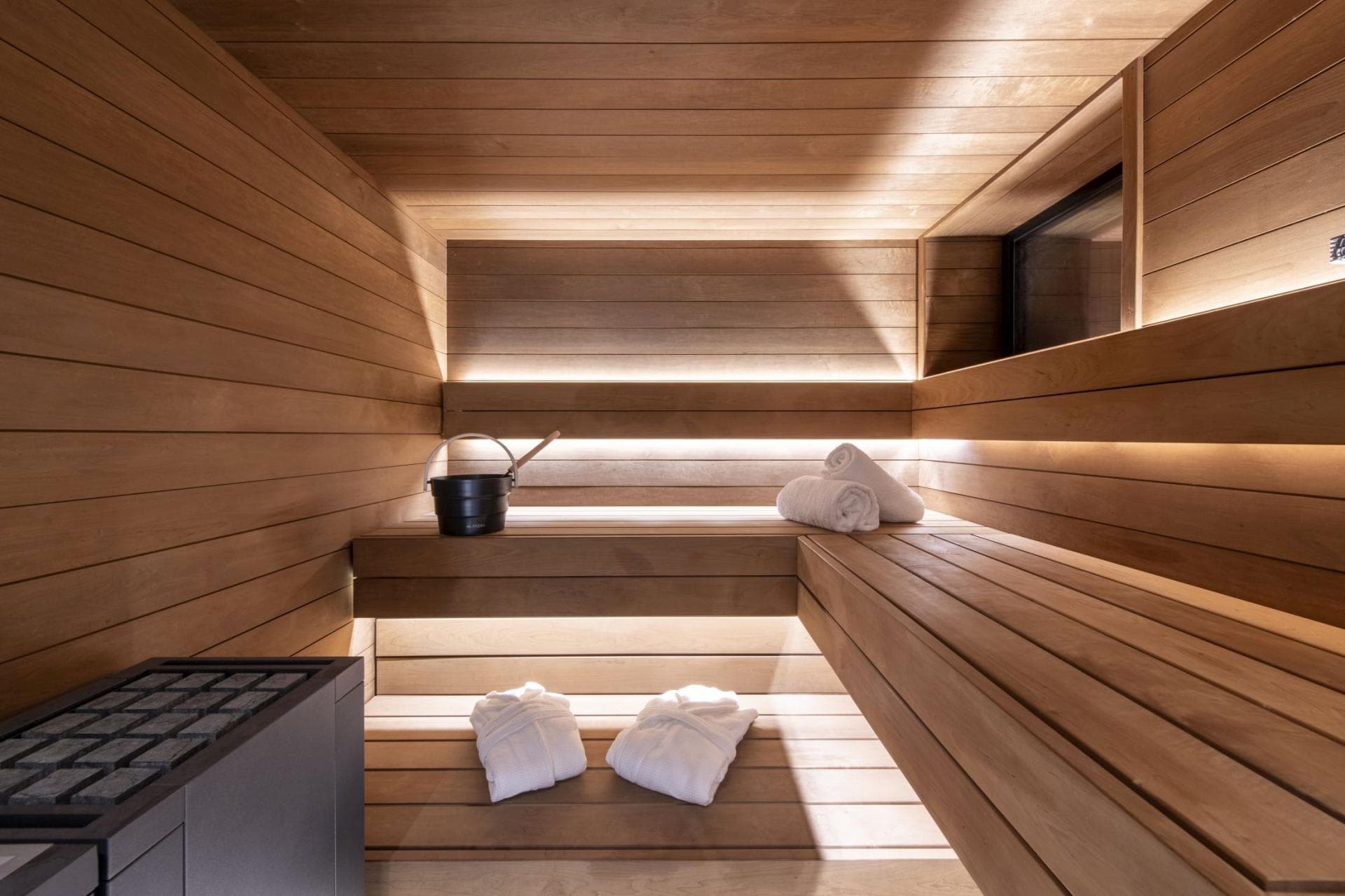 Cedar sauna with multi-level bench seating and integrated LED lighting