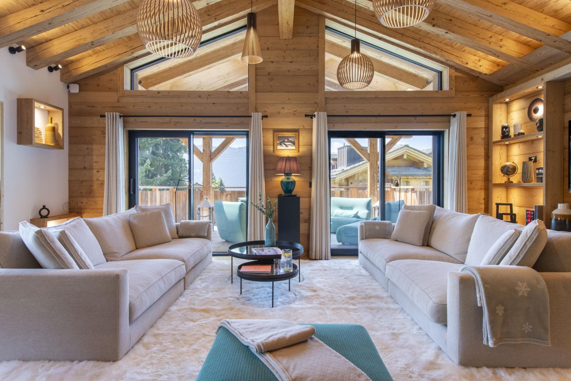 Living area with vaulted ceilings and deck access through sliding doors