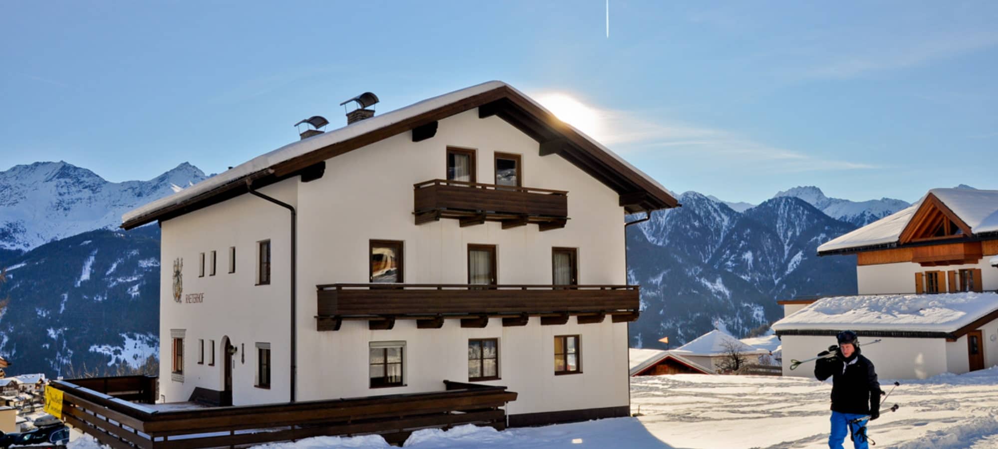 Chalet exterior featuring wooden balconies and panoramic mountain views