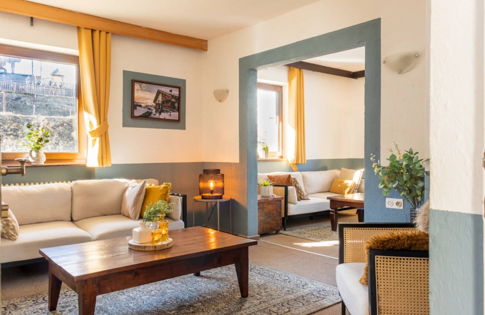 Living room with dual seating zones and hillside views