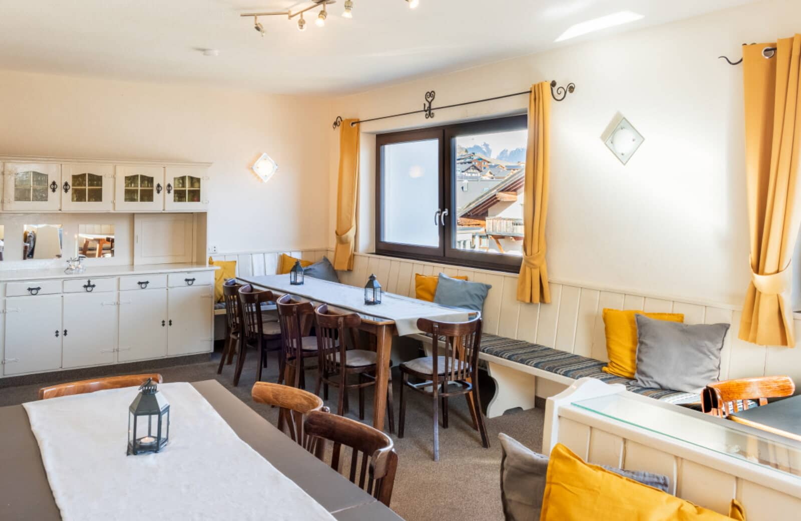 Dining area with bench seating and views of snow-capped peaks