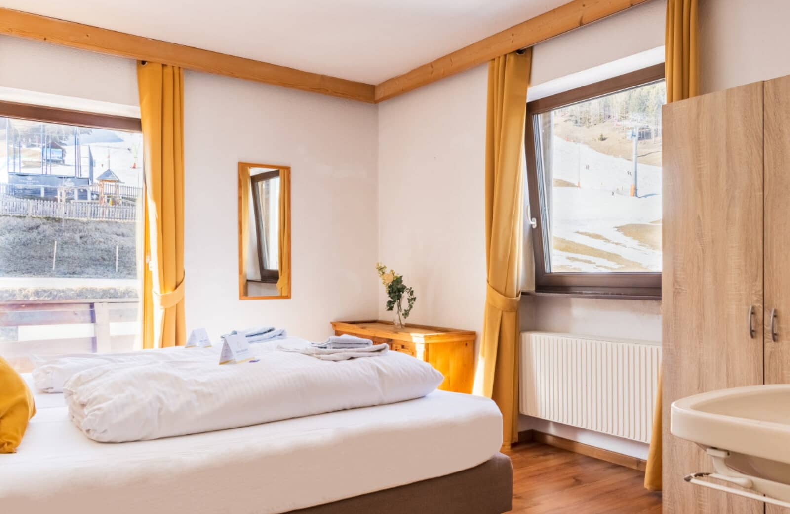 Bedroom with in-room sink and direct ski slope views