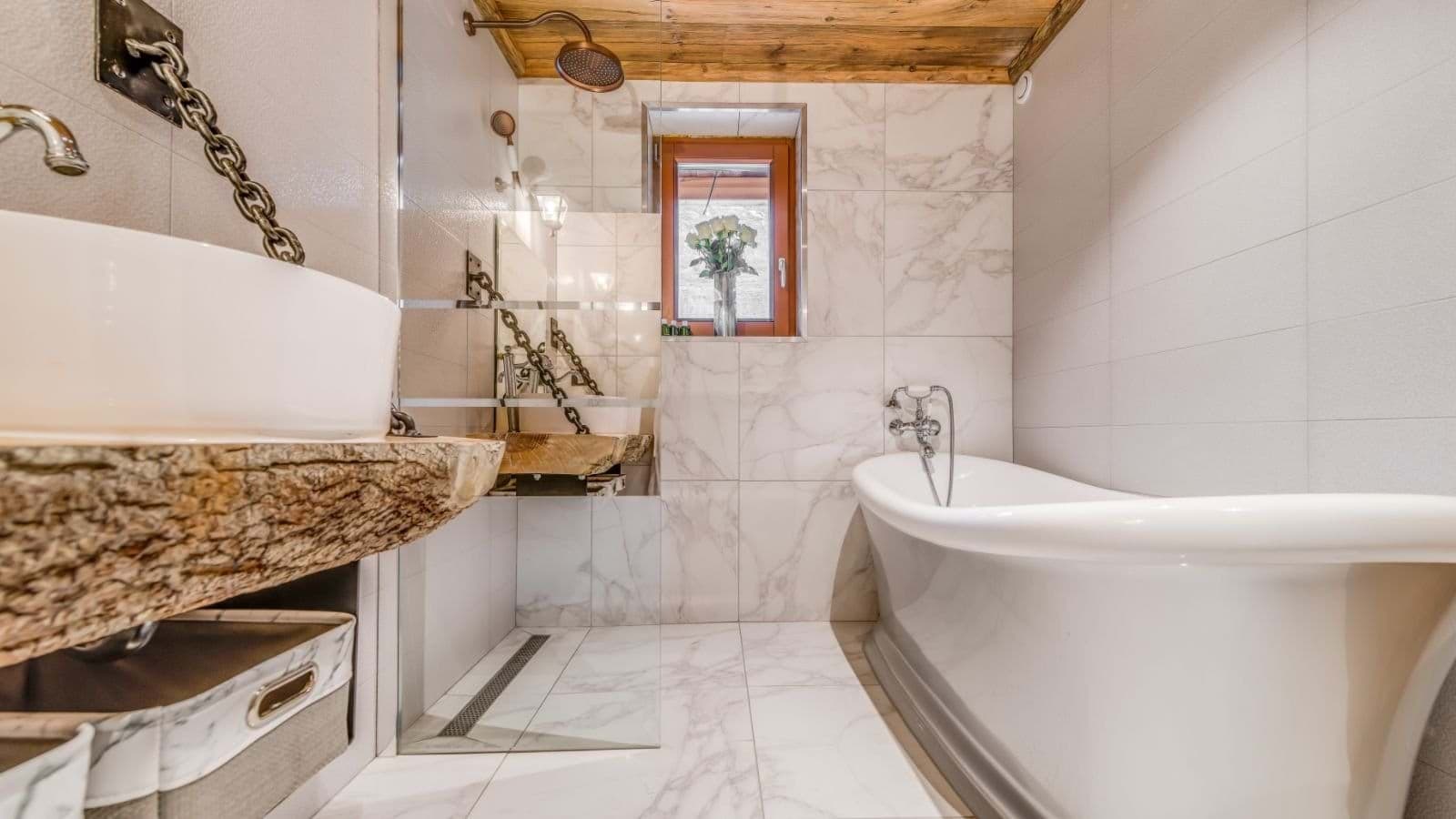 Bathroom with clawfoot tub, walk-in rainfall shower, and live-edge wood vanity