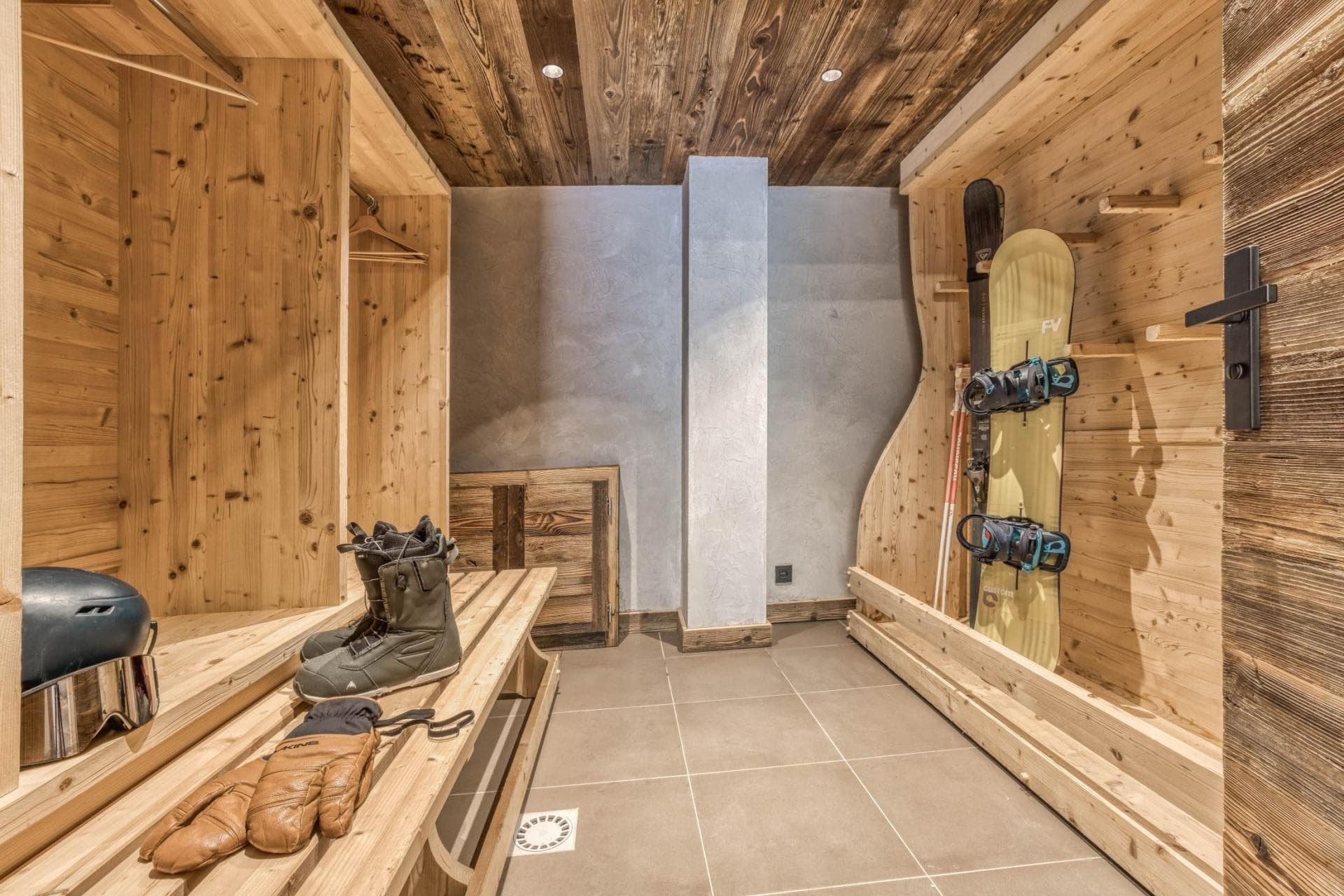 Ski room with dedicated gear storage, bench, and floor drain